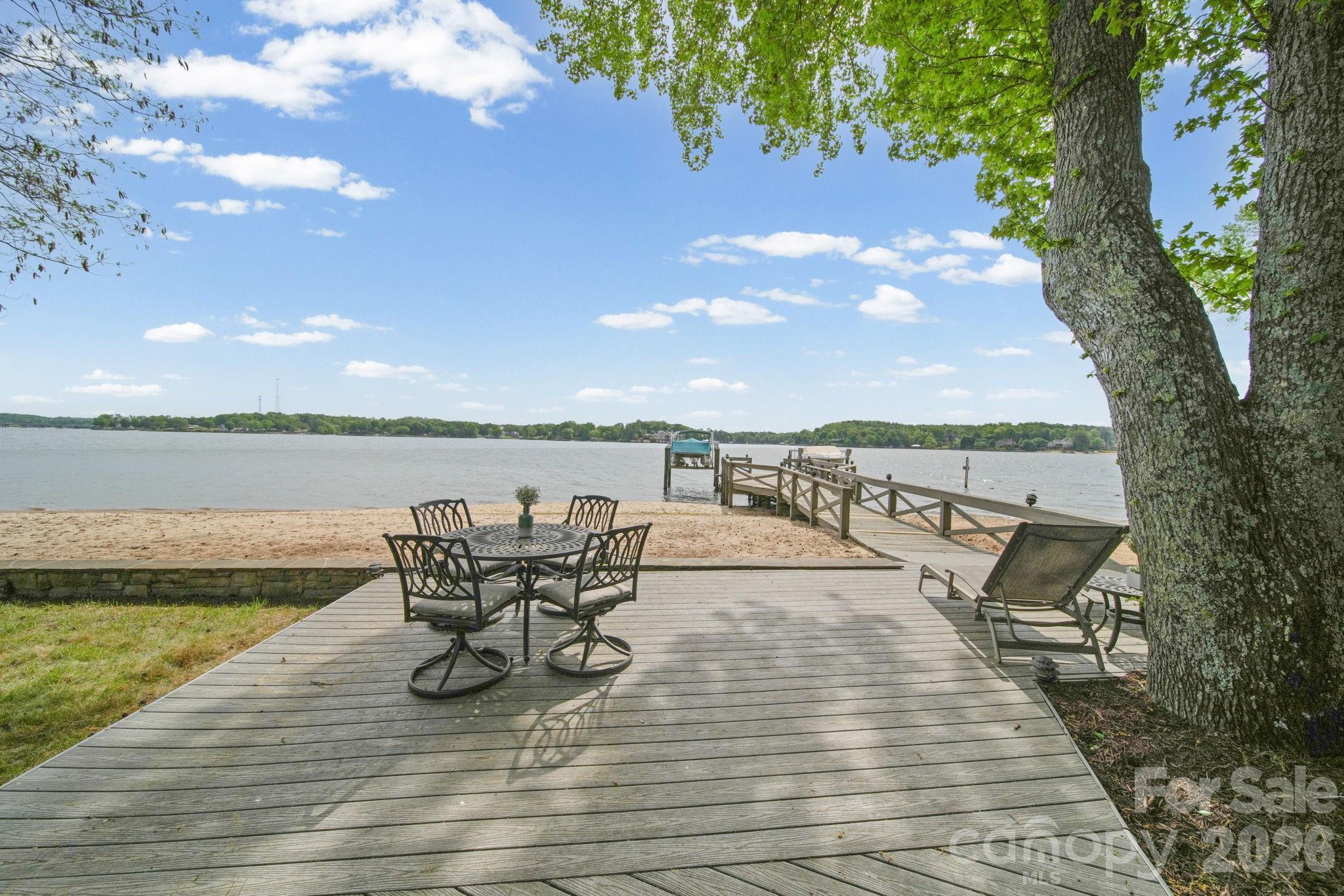 Welcome to a rare waterfront retreat in the highly sought-after River Hills community, where everyday life feels like a getaway. With your own private sandy beach just steps away, mornings start with coffee by the water and end with sunsets that never get old. 

Inside, natural light pours in and highlights a thoughtfully designed layout featuring 3 spacious bedrooms, and 3 full bathrooms, a dedicated home office/laundry room for everyday ease. The primary suite offers peaceful water views, creating a calming escape at the end of the day. High-quality finishes run throughout, including hardwood floors, tile, and upgraded carpeting.

The kitchen is both functional and impressive, featuring a gas cooktop range, double oven, Kenmore Elite appliances, and a side-by-side wall refrigerator and freezer, making it ideal for entertaining or everyday living.

This home has been thoughtfully updated with all newer windows and doors (2023) and a tankless water heater, offering both efficiency and modern comfort.

Outdoor living is where this home truly shines. A huge composite deck and walkway lead to a spacious patio area overlooking the water, complemented by a screened porch for year-round enjoyment. The shared dock (with neighbor) includes a boat lift, making lake days effortless, and irrigation keeps the landscape looking its best.

And the lifestyle doesn’t stop at your doorstep. Hop on your golf cart and cruise through this vibrant, amenity-rich community featuring a marina, country club (membership available—please ask LA how to inquire), playground, and a public beach to enjoy in addition to your own private shoreline. River Hills Country Club adds even more to the experience with golf, dining, and social opportunities.

All of this is set within a gated community offering security and its own emergency squad, providing both peace of mind and a true sense of community.

With abundant storage throughout and a setting that blends comfort, beauty, and functionality, this home is the perfect balance of relaxed waterfront living and refined design.