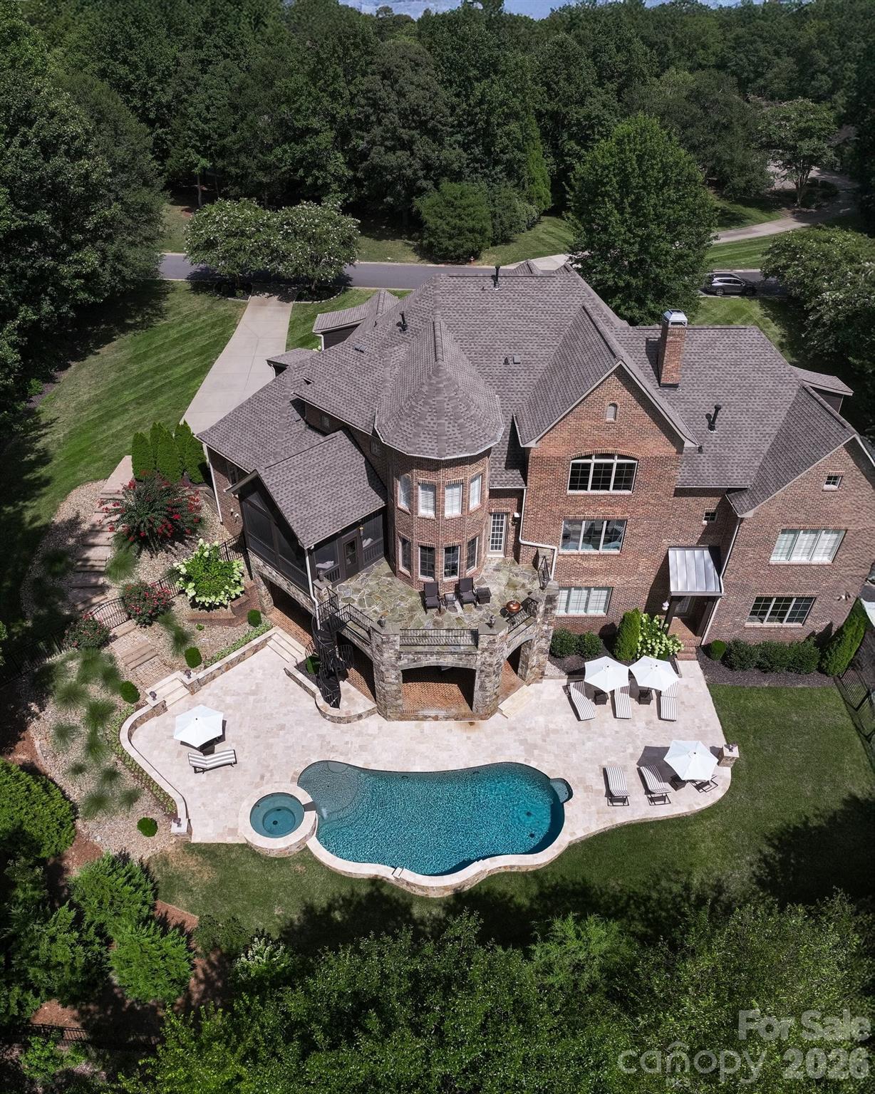 Exceptional brick home on 13th tee box of Country Club of the Carolinas w/ a private backyard oasis.  Heated pool, spa & travertine pavers create resort-style retreat. Main level features:10' ceilings, oak floors, office w/ vaulted ceilings, wet bar & built-ins. Spacious primary suite on main w/ vaulted ceilings, 2 walk-in custom closets & dual vanities. Main-level guest suite w/ full bath. 2 story great room opens to chef’s kitchen w/ oversized granite island. Upstairs offers 3 bedrooms, 3 full baths & private living room suite. Expansive basement includes a bar w/ dishwasher, family room w/ fireplace, full bath & over 1600 sq ft of unfinished space—already stubbed for plumbing & has HVAC—perfect for a gym, guest suite, or flex rooms. 2022 roof, whole-home water filtration, irrigation, landscape lighting, screened porch w/ fireplace, covered patio w/ fireplace & 4-car garage. Golf course views in a premier country club setting complete this entertainer’s dream right on the state line.