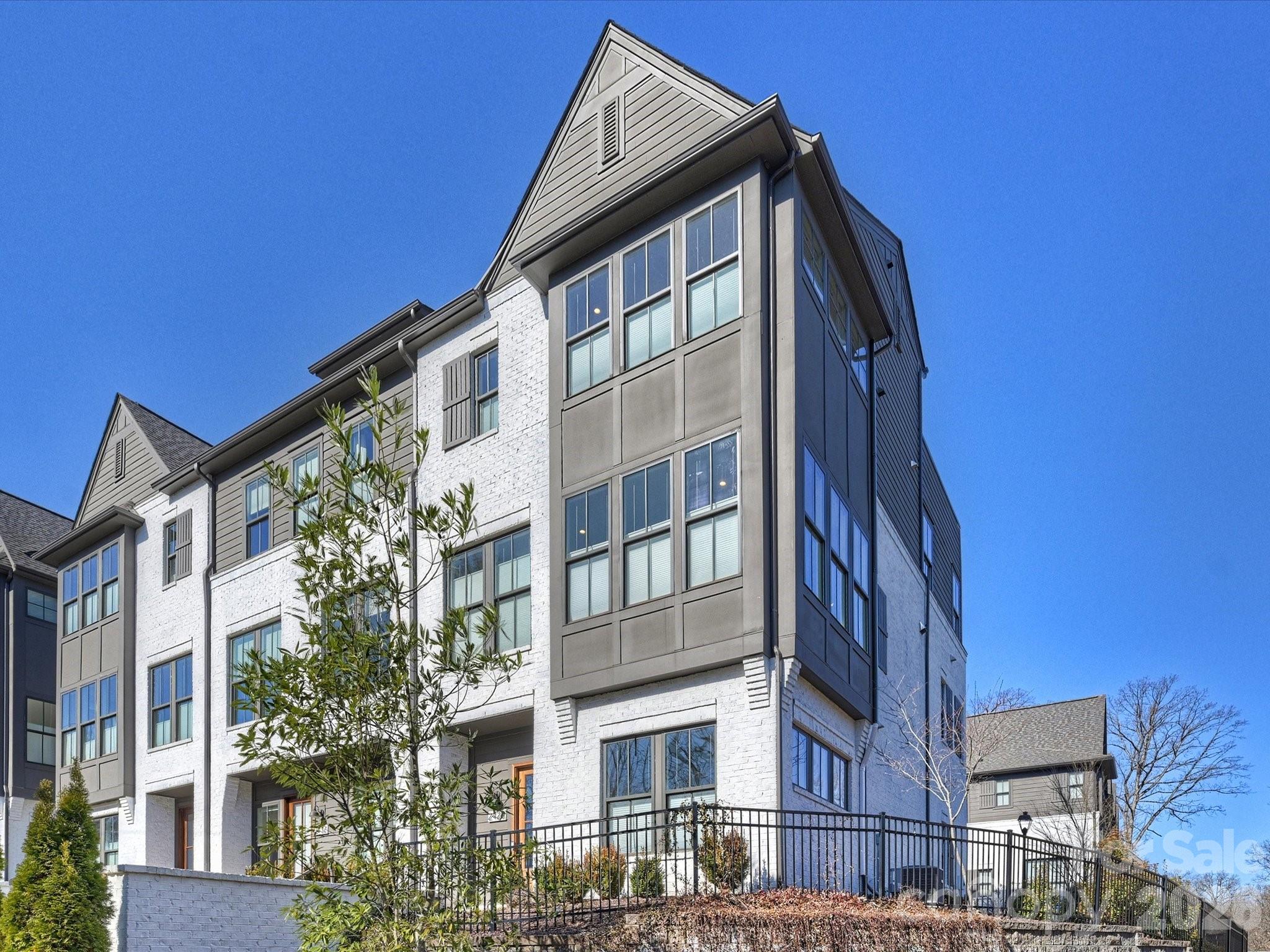 This stunning end unit with a rooftop terrace is what you've been waiting for!  Built by award-winning Hopper Communities with an English cottage-inspired exterior.  The floorplan features an open kitchen/dining/living space with a generously-sized living room, anchored by a gas log fireplace with pre-cast concrete surround, plus an elevator, 10' ceilings with cove molding, and 7" prefinished hardwoods throughout.  The kitchen is a chef's dream with Calcutta Gold Suede quartz countertops, stainless appliances and high end cabinetry.  The 4th floor flex space includes a wet bar and half bath, great for entertaining, office or exercise space.  All of the interior finishes were thoughtfully selected, creating a harmonious and sophisticated living experience.  Enjoy scenic views of the Briar Creek Greenway from the large rooftop terrace.  Easy access to many shops and restaurants, just around the corner.