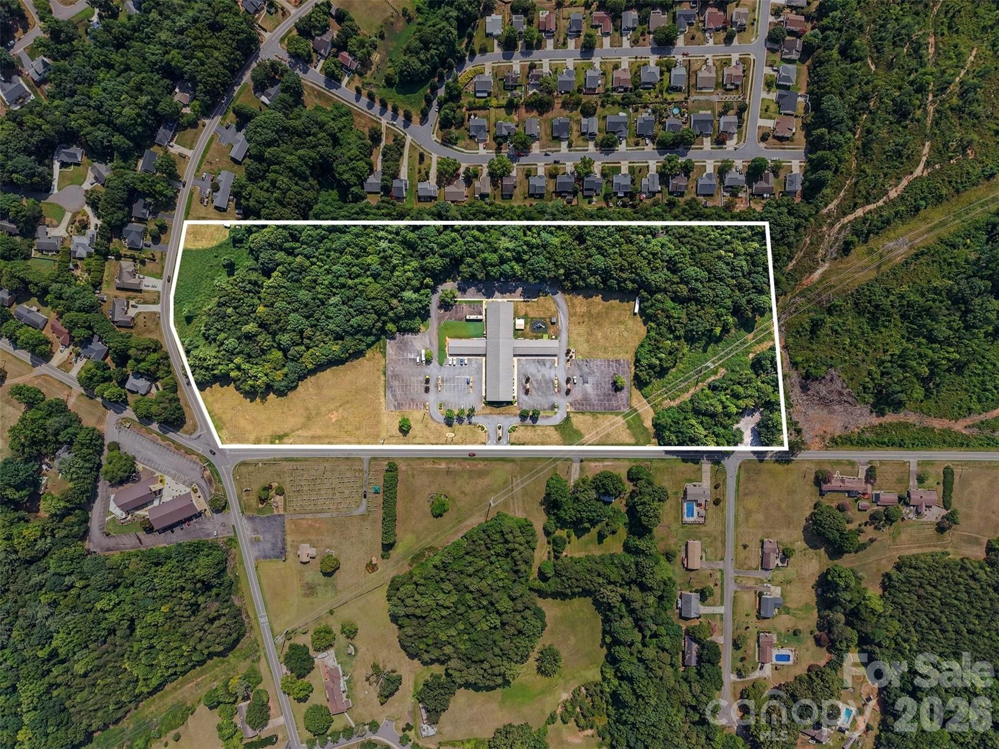 Premier Commercial Opportunity with Exceptional Highway Frontage

With nearly 1,800 feet of frontage on NC Highway 127, this property offers the kind of visibility and exposure that simply cannot be replicated. Positioned on one of Hickory's busiest commercial corridors, this exceptional 18.34-acre campus commands a prominent corner location at 6th Street SE (NC Highway 127) and 18th Avenue SE, benefiting from outstanding daily traffic counts, easy accessibility, and exceptional signage opportunities.

The property is improved with a well-maintained 28,472-square-foot brick facility featuring expansive gathering spaces, numerous classrooms and offices, commercial kitchen facilities, meeting rooms, recreational areas, and a fully finished lower level with both interior and exterior access. The flexible layout is ideally suited for a wide range of commercial, institutional, educational, medical, nonprofit, or redevelopment uses.

Beyond the existing improvements, the expansive site offers extensive paved parking, city water and sewer service, and significant room for future expansion or redevelopment. The property's substantial highway frontage provides an unmatched opportunity for business visibility, brand recognition, and customer access while maintaining a spacious campus-like setting.

Conveniently located just minutes from Interstate 40, Downtown Hickory, Catawba Valley Medical Center, and surrounding residential communities, this strategic location places your organization or investment at the center of one of Western North Carolina's fastest-growing commercial markets.

Whether envisioned as a corporate headquarters, educational campus, place of worship, medical facility, community center, event venue, mixed-use redevelopment, or long-term investment, 1855 6th Street SE presents a truly rare opportunity to acquire one of Hickory's most recognizable and strategically positioned commercial properties.