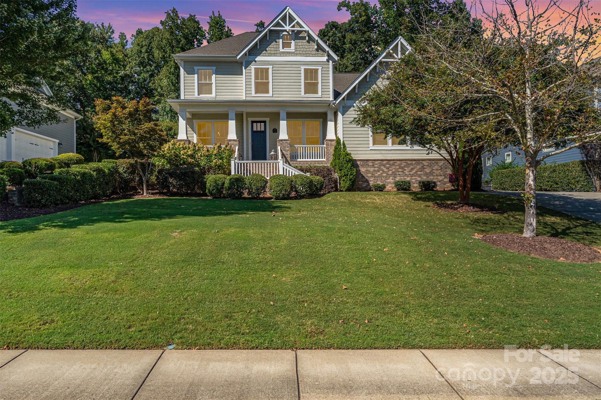 Welcome to a truly exceptional home in the highly sought-after Springfield community of Fort Mill, SC. This stunning Arts and Crafts-style residence offers a blend of luxurious living, modern amenities, and a private, serene setting. This expansive 5-bedroom, 3.5-bathroom home boasts a generous amount of living space, with an open floor plan that is perfect for entertaining. The main level features a primary bedroom suite, a dedicated office and open living space while the second floor offers three additional bedrooms, a loft and a bonus room. The heart of the home is a chef's dream, featuring a large island, stainless steel appliances, a gas cooktop stove, and a walk-in pantry. Step outside to an expansive screened-in covered patio that overlooks a flat, fenced yard and 18th fairway. This private outdoor living space, complete with a fire pit, is perfect for relaxing with family and friends. The property is a private, wooded lot, offering both privacy and natural beauty. Enjoy the luxurious lifestyle of the Springfield community, which offers an array of amenities including a golf course, clubhouse, fitness center, community pool, playgrounds, tennis courts, and walking trails. Conveniently located just minutes from I-77, this home provides easy access to the Charlotte Douglas International Airport and Uptown Charlotte, making it an ideal choice for commuters. The highly-rated Fort Mill School District further adds to the appeal. This home features beautiful hardwood floors throughout the main level, tray ceilings, a gas log fireplace, and a three-car oversized garage. This home offers an unparalleled opportunity to live in one of the area's premier communities. With its combination of a well-designed interior, fantastic outdoor spaces, and a location that provides both a tranquil escape and convenient access to city amenities.