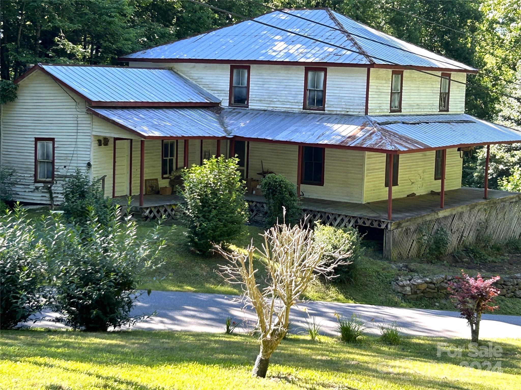 One of a kind historic 1904 family homestead and a 2 bedroom/1 bath remodeled manufactured home on 5.79 mountain view acres.  Bold streams flow by both homes with paved road and gentle sloping yards. This is a rare opportunity to restore a 2300 sq ft home built by one of the oldest families in Western NC. This is a must see to appreciate estate. Anyone familiar with turn of century construction will appreciate the bead and board walls and ceilings, wide oak and chestnut flooring and beautiful heart pine stairs. Convenient to Blue Ridge Parkway, Waynesville, Sylva, Cherokee and Asheville. No septic on file