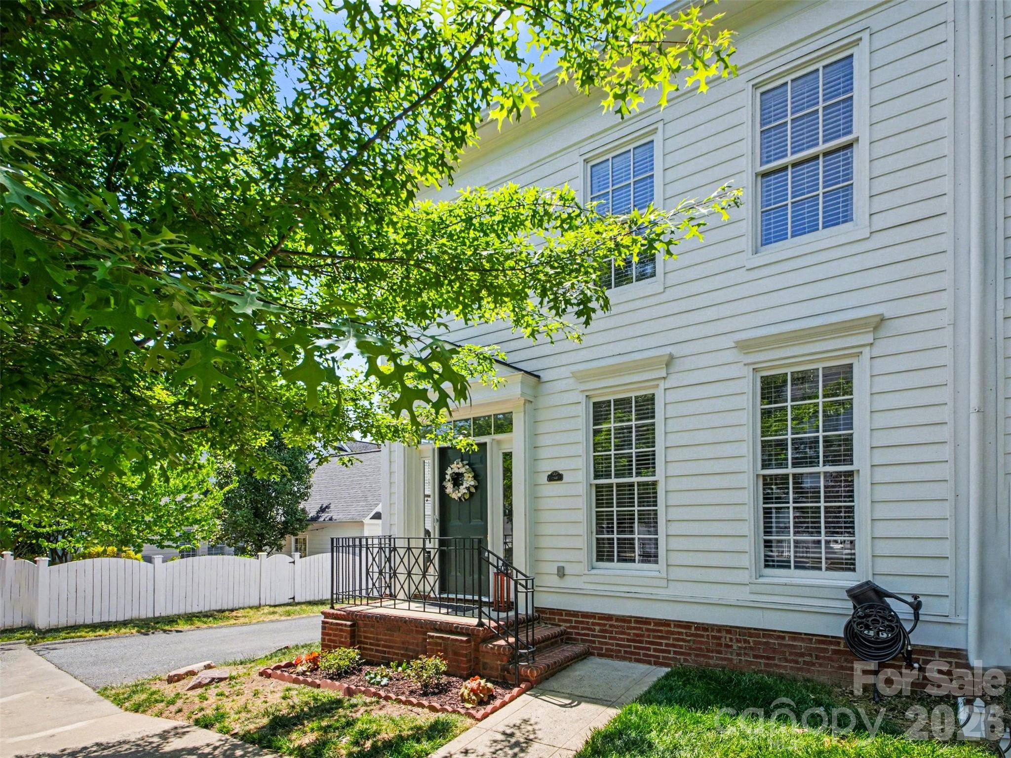 Welcome to this end-unit townhome in Vermillion, where modern comfort meets true walkable neighborhood living. Natural light fills the open floor plan, featuring luxury vinyl plank flooring throughout the main level. The kitchen includes a peninsula for additional seating, subway tile backsplash, and ample cabinet and counter space. Upstairs are three bedrooms offering flexibility for family, guests, or a home office. Nestled between the main level and detached two-car garage, the private patio is fully fenced with a gate ideal for pets and playing. 
Vermillion amenities include two saltwater pools — one walkable and adjacent to the neighborhood playground — plus scenic walking trails and a vibrant community calendar featuring Food Truck Fridays, community garage sales, and more. Harvey's, the neighborhood's own restaurant, is steps away. What sets this location apart is the walkability. A 15–20-minute stroll along continuous sidewalks connects you to downtown Huntersville's breweries, restaurants, future bakery and wine bar, park, and pickleball courts. A planned greenway running directly through Vermillion will connect the neighborhood to the downtown greenway.