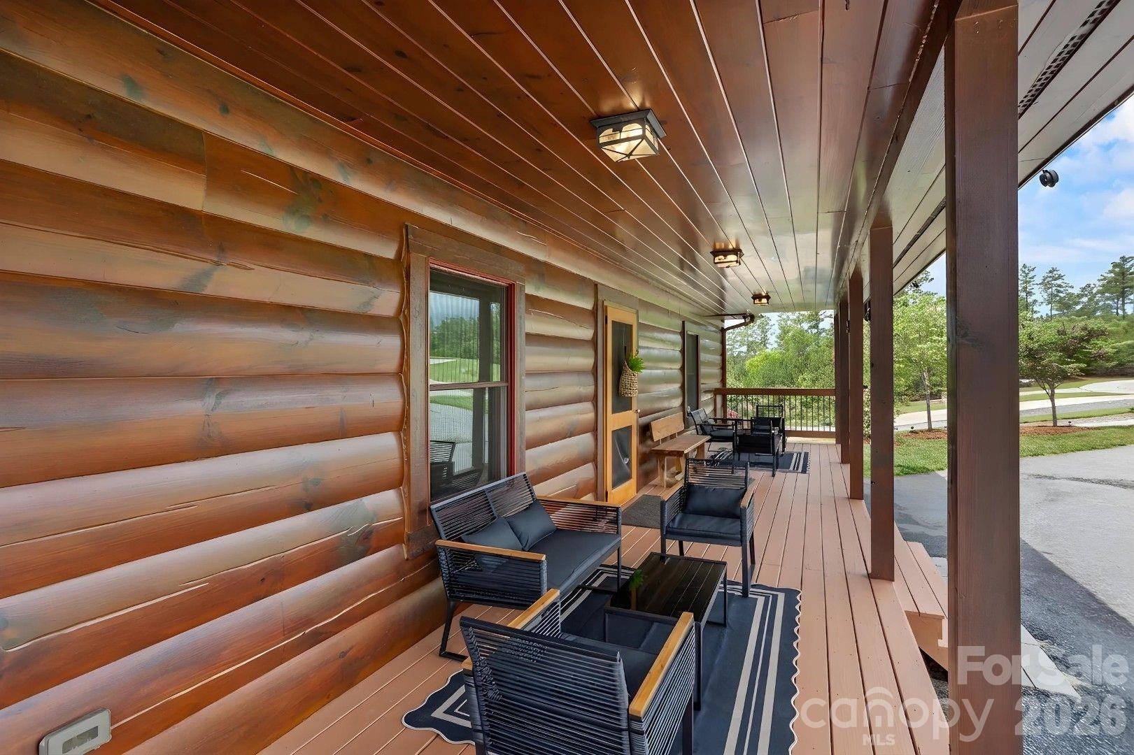 PRICED BELOW APPRAISED VALUE! Immediate equity at this turnkey, dock-eligible waterfront sanctuary on Lake Rhodhiss. Nestled on 1.79 acres in a premier gated community, this crafted 4BR/3BA one-level cabin boasts 250+ linear feet of cove frontage (Duke Energy dock eligible). The main level shines with engineered hardwoods, tongue-and-groove pine walls, cedar beams, a stone fireplace, and a premium kitchen with granite countertops, custom maple cabinets, and a walk-in pantry. Authentic Amish furniture conveys, making this a turnkey luxury retreat! The lower level features Superior Walls foundation, a finished walk-out basement with soaring 10-foot ceilings, and a spacious patio. Enjoy cool breezes from the screened-in deck under a low-maintenance metal roof. Incredible location near Castle Bridge Boat Access and Marina or Conley Creek access at Sawmill Veterans Park. Also included is a 12x20 Amish-built storage building, a whole-home water filtration system, and generous gathering spaces for guests and family perfect for relaxing.