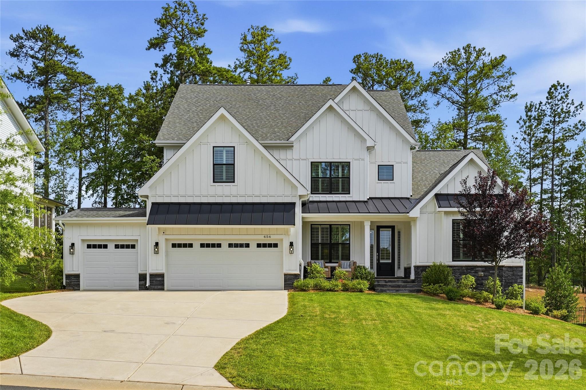 There’s a reason homes in Nims Village are so highly sought after. With tree-lined streets, established landscaping, welcoming front porches, and a location that places you minutes from some of Fort Mill’s most desirable schools, shopping, dining, and everyday conveniences, it’s the kind of neighborhood people move into and rarely want to leave. Built by Knotts Builders in 2022, this beautifully maintained Greenville plan offers over 3,500 square feet of thoughtfully designed living space, blending modern finishes with a floor plan that lives comfortably every day. A main-level owner’s suite, dedicated office, spacious living areas, and rare 3-car garage make this home as functional as it is beautiful. At the heart of the home, the gourmet kitchen was designed for gathering, featuring quartz countertops, built-in stainless steel appliances, a gas cooktop, wall oven, oversized island, and adjoining morning room filled with natural light. The open-concept family room creates an inviting space for everything from quiet evenings at home to hosting family and friends. The owner’s retreat offers a peaceful escape with a freestanding soaking tub, walk-in tiled shower, dual vanities, and spacious walk-in closet. Upstairs, four additional bedrooms, multiple full baths, and a generous bonus room provide flexibility for growing families, guests, hobbies, or work-from-home needs. Located near River Trail Elementary, Banks Trail Middle School, and Catawba Ridge High School, this home offers the opportunity to enjoy one of Fort Mill’s most established communities while still enjoying the benefits of newer construction. Beautifully maintained and thoughtfully designed, this is a home that simply feels good the moment you walk through the door.