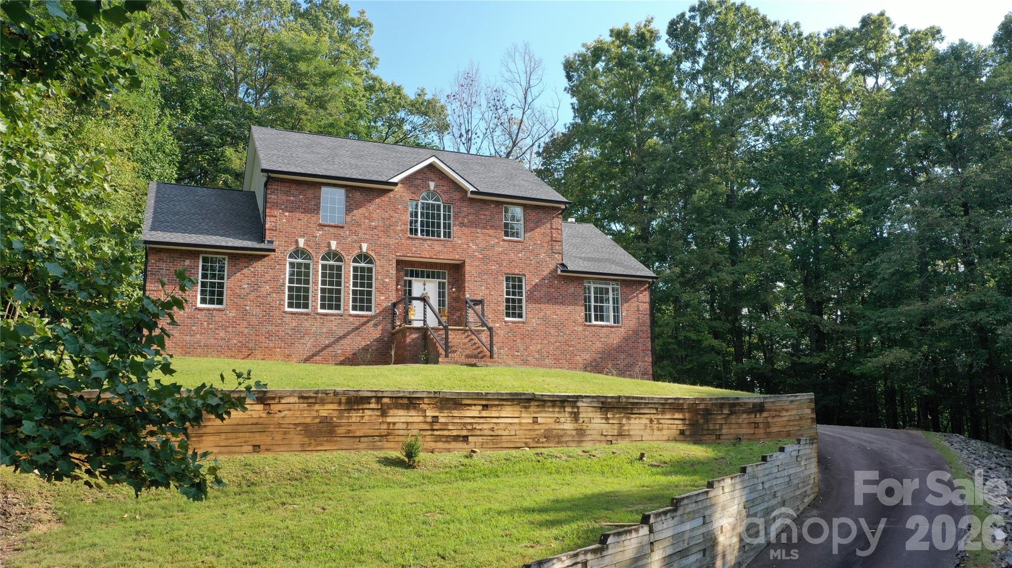 Experience peaceful mountain living at 1064 Skye Drive:  A serene 3-bedroom, 4-bath home tucked within the beautiful Glen Cannon community of Pisgah Forest. Resting on .69-acres surrounded by mature trees, this spacious two-story home with a finished basement offers privacy, comfort, and lovely winter views of the Blue Ridge Mountains.
The inviting main level features warm hardwood floors, a comfortable living room with a cozy fireplace, and a well-designed kitchen that opens to the dining area. From the breakfast nook, step out onto the screened porch or large deck to enjoy the sounds of nature and gentle mountain breezes. The main-level primary suite is a tranquil retreat with its own fireplace, sitting room, and private bath.
Warm hardwood floors continue upstairs where you’ll find two restful bedrooms, a full bath, and a large open living space overlooking the lower level. The finished basement provides additional living space with a full bath and plenty of room for hobbies, guests, or relaxation. 
Surrounded by natural beauty and just minutes from downtown Brevard and Pisgah National Forest, this peaceful mountain home blends comfort, charm, and privacy—offering the perfect setting to unwind and enjoy life in the North Carolina mountains.