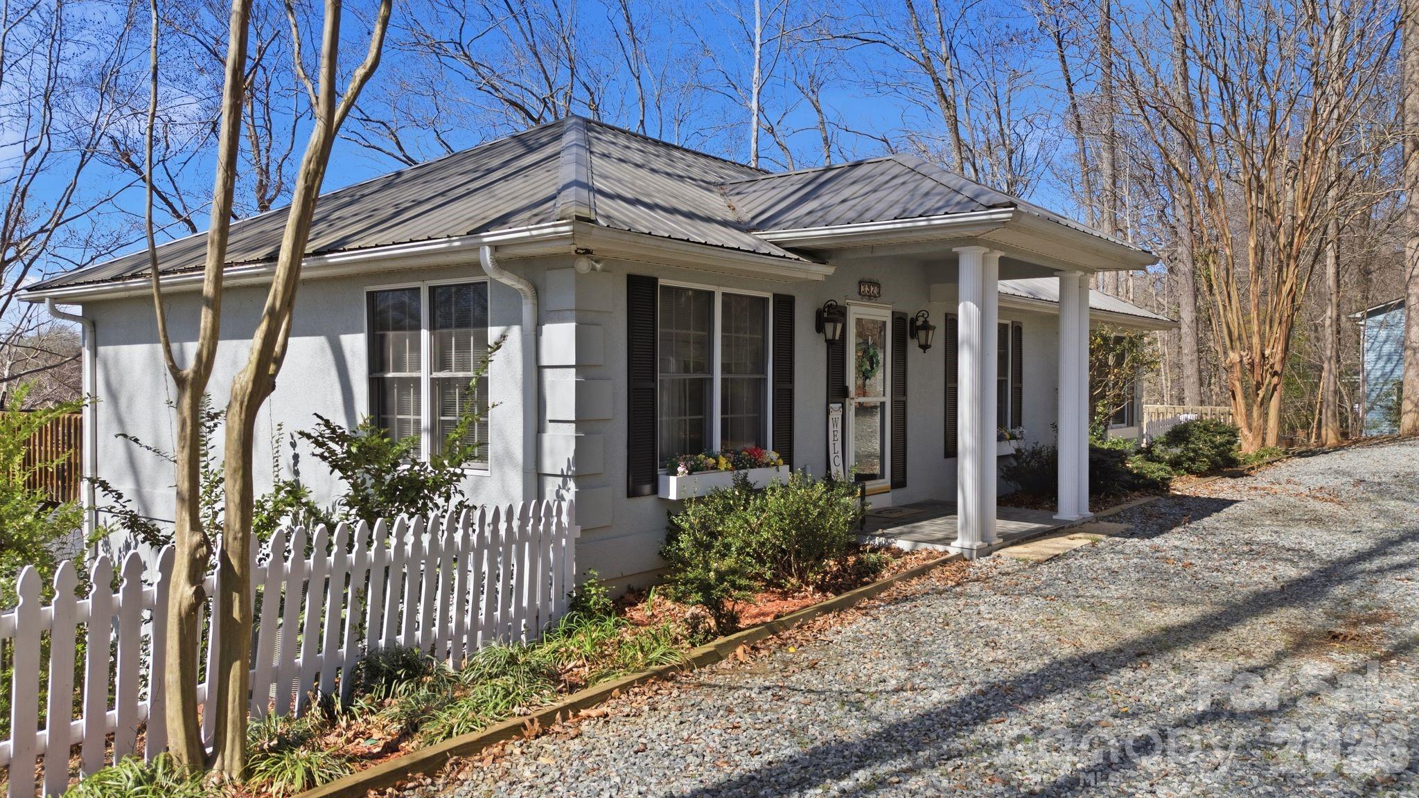 This beautiful lakefront home sitting on a 2.5+ acre lot, offers the ideal blend of privacy, comfort, and scenic water views! You'll love the HUGE newer private dock with covered boat slip and floater! Inside with primary on main, the open-concept floor plan creates an inviting flow between the main living spaces, highlighted by a cozy fireplace in both the living room and the lower-level great room. Step outside to experience true indoor-outdoor living with a lakeside deck, screened-in porch, and a lower-level covered patio. Tax value $643,550 reflects the new 2026 Davidson County valuation. Tax rate and total tax amount listed are based on 2025 figures. 2026 tax rate projected TBD mid-2026.  Pier permit with Cube Hydro: $100 annual renewal fee. One-time $175 pier transfer fee to be paid by buyer at closing. Preapproved buyers welcome!