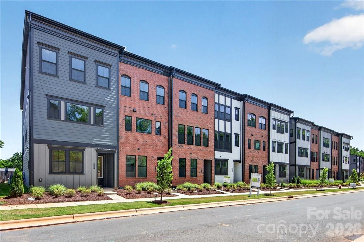 Welcome to 440 Old Town Village Rd, where modern design and small-town charm come together in this stunning three-story Duncan townhome. A covered front entry welcomes you inside, where the first floor offers a private third bedroom with a full bath featuring a tiled walk-in shower, ideal for guests or a home office. Ascend the elegant oak box stairs with open rails to the second floor, where the heart of the home awaits. The gourmet kitchen impresses with white cabinetry, white quartz countertops, a 4x12 Mythology Olympus Gloss backsplash, and a large single-bowl stainless steel sink with a Delta Essa Touch faucet, all anchored by a GE 36" gas cooktop built for the home chef. On the third floor, the primary en suite is a true retreat, showcasing a tiled walk-in shower and rich grey cabinetry paired with white quartz countertops. With 3 bedrooms, 3.5 baths, and premium finishes throughout, this home is as functional as it is beautiful, perfectly positioned just steps from the shops, dining, and charm of historic downtown Waxhaw.