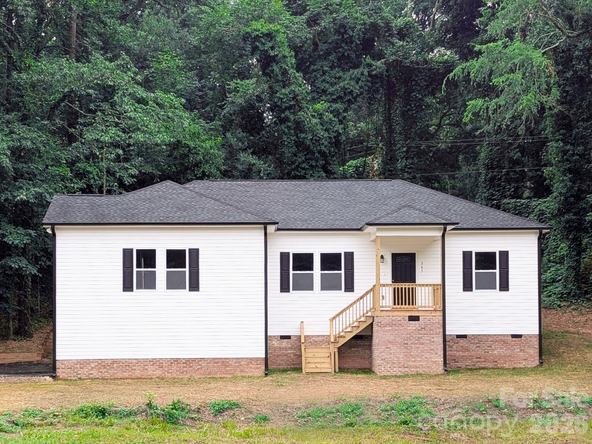 Beautiful 3BR/2BA home on a spacious half-acre lot in the heart of York, SC! Located in an established neighborhood, this home offers an open-concept layout with luxury vinyl plank flooring throughout, perfect for everyday living and entertaining. The kitchen and bathrooms feature granite countertops, white soft-close cabinetry, and quality Moen fixtures. The spacious primary suite includes a private en-suite bath, while both bathrooms are equipped with durable fiberglass shower units for easy maintenance. Enjoy the added privacy of a wooded backyard and a home set back from the street, plus a 10x10 deck, perfect for relaxing and enjoying summer nights. Additional highlights include insulated vinyl windows and garbage disposal. The extended driveway provides plenty of room to park and turn around with ease. This move-in ready home combines comfort, functionality, and privacy, all in a convenient York location!