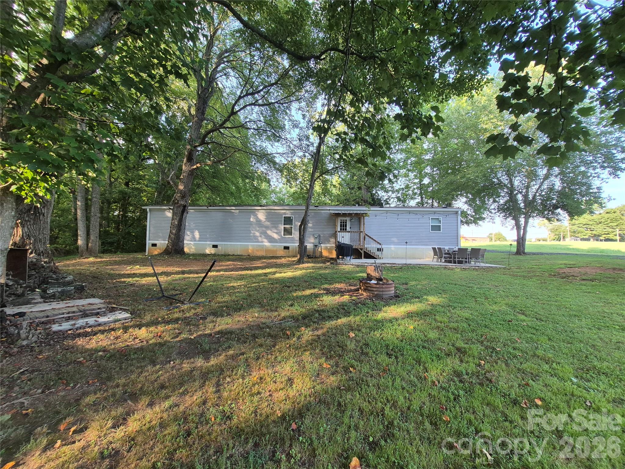 Looking for a place to call your own instead of paying someone else's mortgage? This Energy Star home, built in 2021, offers over 1,200 square feet of comfortable living space on 3.3 private acres in desirable Western Lincoln County.  Surrounded by mature shade trees, this peaceful setting is perfect for relaxing evenings or entertaining family and friends. Inside, you'll find two spacious bedrooms, each with a walk-in closet. The primary suite features a private bath, while a second full bath, generous laundry room, and 3-foot-wide hallway provide added convenience. The open-concept kitchen flows seamlessly into the living room and features abundant cabinet and counter space, a stainless-steel farmhouse-style sink, and a built-in island/table that's perfect for everyday meals. Vinyl flooring runs throughout, and shiplap-style wall accents add warmth and charm.  
Recent updates include a 20' x 20' carport (2026), a 12' x 24' carport (2026), new gutters (2026), septic system pumped (2026), and a concrete patio added in 2023. 
With many two-bedroom apartments renting for $1,200 to $1,500 per month, this property offers an excellent opportunity to build equity instead of paying rent. Enjoy the privacy of 3.3 acres today, with the flexibility to build your dream home in the future while keeping or selling the existing home. Mls@440451 $220,000