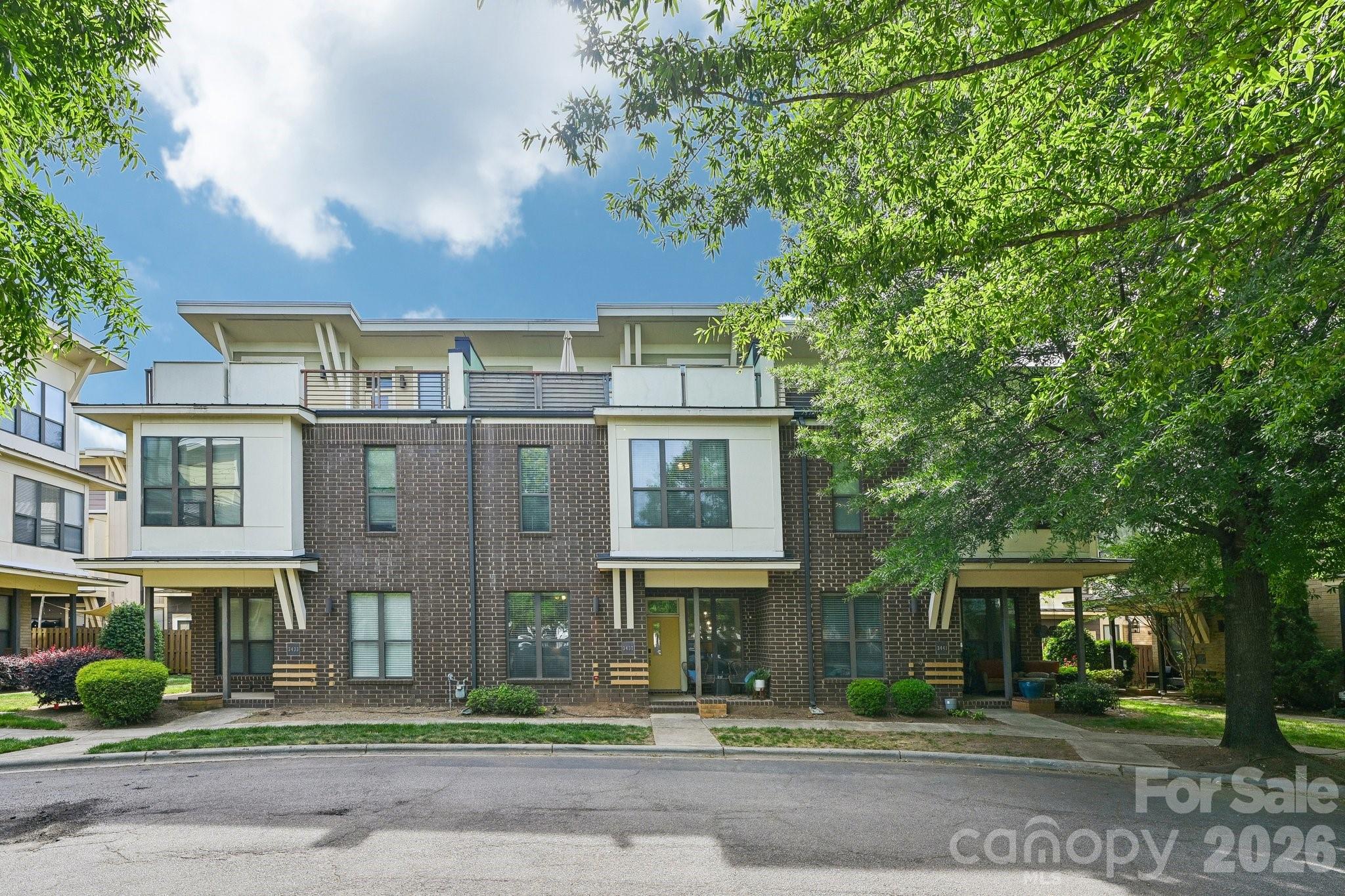 Welcome to the heart of NoDa—where vibrant city living meets comfort, flexibility, and style. This three-story townhome offers a thoughtfully designed layout with multiple living areas and outdoor spaces that make everyday living and entertaining effortless.

The main level features hardwood floors and an open-concept design, seamlessly connecting the kitchen, dining, and living areas. The kitchen is well-appointed with granite countertops, stainless steel appliances, ample cabinetry, and a center island—perfect for gathering or casual dining.

Upstairs, spacious bedrooms provide comfortable retreats, including a primary suite with dual vanities, a garden tub, and a separate shower. The top level offers a versatile bonus space complete with a wet bar and access to a large terrace—ideal for entertaining, working from home, or creating a private getaway.

Outdoor living is just as appealing with a welcoming front porch and a private fenced patio—perfect for relaxing or enjoying time with friends.

Located just minutes from NoDa’s dining, entertainment, and light rail access, this home offers the convenience of urban living with the comfort of a well-designed townhome.