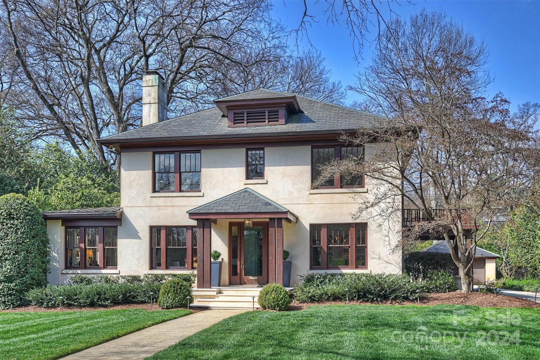 Well maintained Traditional home in highly desirable Historic Dilworth and street. Classic space with an open floor plan and many updates. Original hardwood flooring throughout the main level. Bright entry into formal living room, private office/sunroom w/ fireplace. Powder room, formal dining room, spacious great room w/fireplace & built-ins. Elegant sitting room with bar and beverage fridge that features French doors to the private side yard. Large updated Kitchen w/ sub zero fridge and designated breakfast area. Mud room and Laundry located off kitchen. Primary bedroom located on the second level, features fireplaces, 2 walk-in closets and a large master bathroom with soaking tub. Additional 4 bedrooms and 2 updated bathrooms located on the second level. 

Home provides ample parking with large driveway, detached garage and attached carport. Exterior of the home is masonry hard stucco.