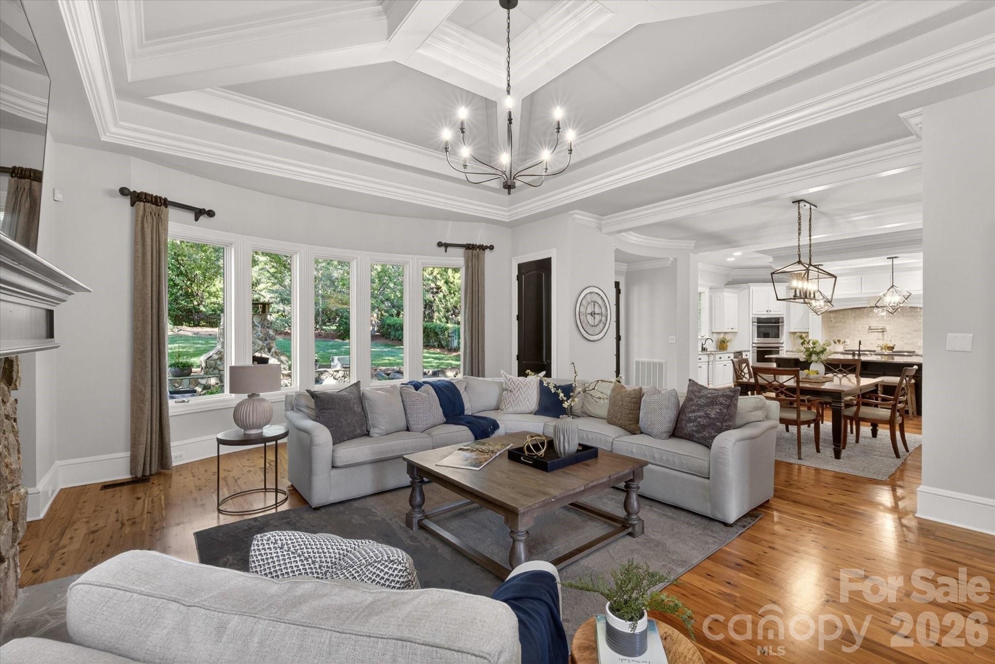 Built by the acclaimed New Traditions, this nearly 8,000 sq ft estate showcases timeless craftsmanship. The expansive floor plan offers gracious living and entertaining spaces alongside comfortable everyday areas, creating a home that is as elegant as it is livable. The Australian Cypress floors are a standout and so durable!  A dramatic two-story foyer with a sweeping staircase sets the tone, leading to beautifully proportioned formal living and dining rooms. The designer kitchen with professional appliances anchors the home with seamless flow into a large breakfast area and an impressive great room, creating an open-concept with expansive views of the outdoors! A private office on the main floor offers refined workspace with convenience and privacy. The upper level showcases four generously sized bedrooms, including a truly luxurious primary suite complemented by a private sitting room retreat, custom coffee bar, and a spa-inspired bath creating a sanctuary of relaxation. Spacious secondary bedrooms and a large bonus room provide flexibility for guests and recreation.  The lower level is a standout, delivering an extraordinary amount of dedicated lifestyle space. Large recreation room and large media room create the ultimate entertainment hub, complemented by a wet bar, and an additional guest suite with full bath. Completing the home is the beautifully designed outdoor living space off the main level, featuring a fenced backyard, patio, and a striking stone fireplace perfect for year-round enjoyment.  World class amenities - neighborhood pond, pool, lazy river, volleyball, playground, fitness center, tennis/pickleball and sport court.  Marvin Schools!