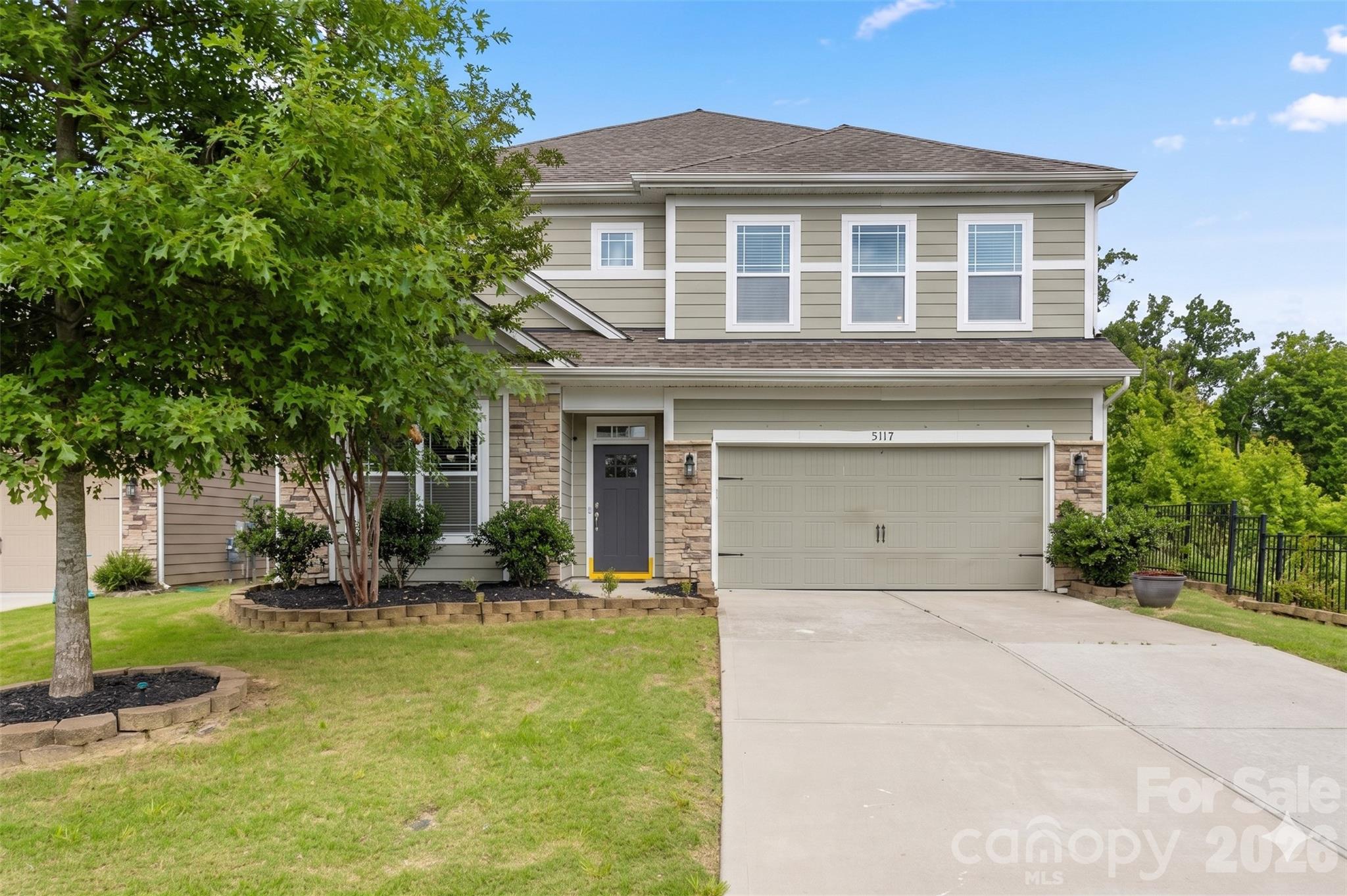 Rare corner-lot gem in award-winning Fort Mill schools! This spacious 5-bedroom beauty delivers unmatched privacy: white vinyl-fenced yard, mature wooded buffer on two sides, and a brand-new extended patio w/ hard-top gazebo — your private outdoor retreat. Abundant natural light & cross ventilation from windows on every wall.

Chef's kitchen impresses with 5-burner gas cooktop, double wall ovens, 
granite island w/ bar seating, SS appliances, subway tile backsplash & 
walk-in pantry. Open to great room w/ gas fireplace & French doors to patio.

Guest BR + full bath on main level. Upstairs: 3 full baths, spacious 
master w/ scenic views, soaking tub, walk-in shower & huge closet. 
Large media/loft perfect for home theater. Formal dining w/ wainscoting & 
chandelier. 2-car garage w/ water filtration system. 

Freshly painted top to bottom, this home is truly move-in ready with nothing left to do but unpack.
Community pool, play area & Stockbridge Commons 5 min away. 
Uptown Charlotte ~25 min. Your forever home awaits!