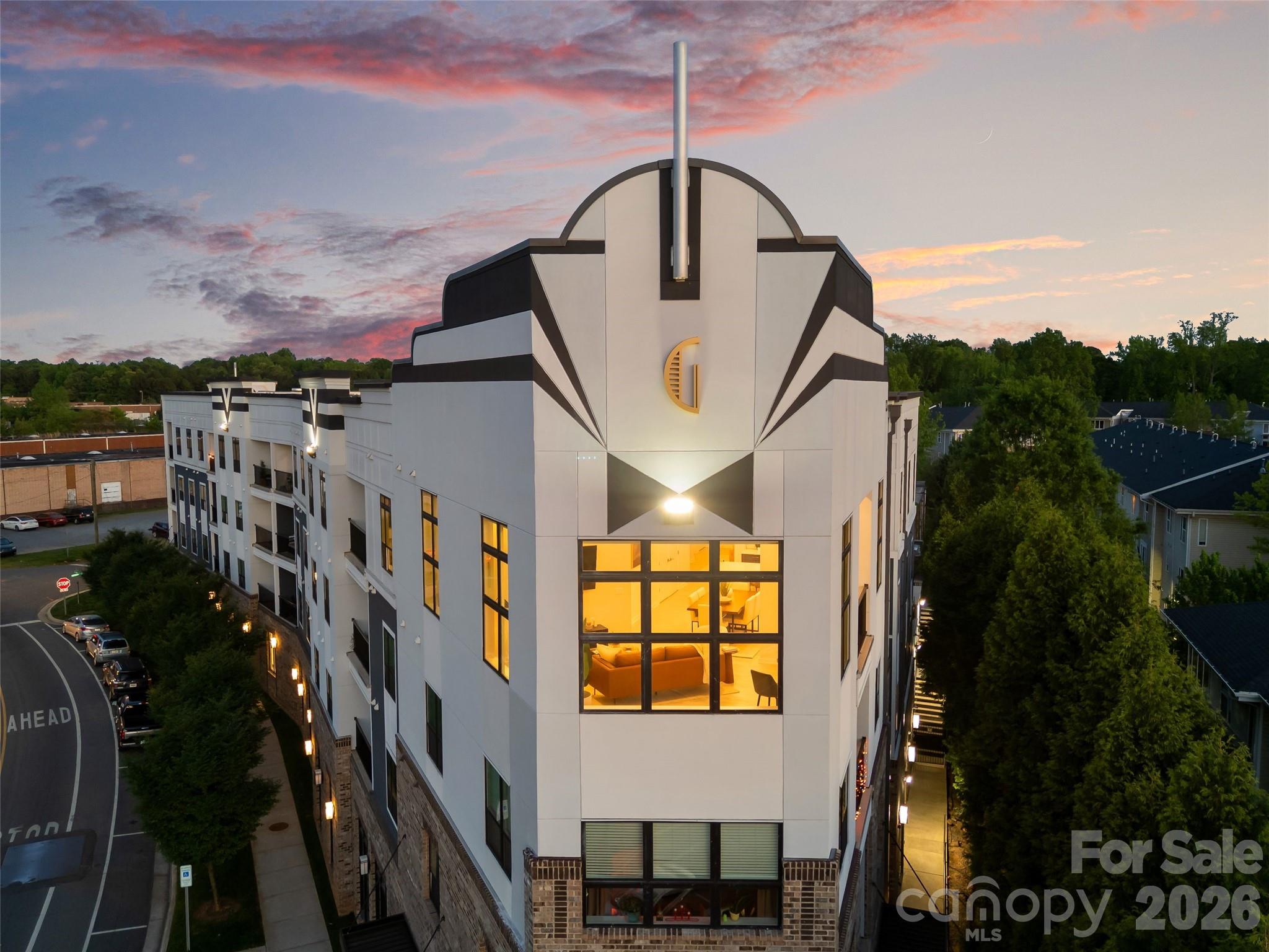 Welcome to a true 1 of 1 opportunity in the booming NoDa neighborhood, Charlotte’s hub for arts and entertainment. This penthouse unit with soaring 12’ ceilings floods every room with light, while walls of glass frame unobstructed western sunset and Uptown skyline views for miles. With no unit or building quite like this nearby or in development in the foreseeable future, this penthouse makes a tremendous investment in one of the most coveted neighborhoods within blocks of the Sugar Creek Lynx light rail station, providing a convenient commute to all that Uptown and beyond have to offer. Residents enjoy a 3,500 sq ft outdoor amenity terrace featuring fire pits, gas grills, and multiple seating and entertainment areas surrounded by mature landscaping. Inside, an open light-filled layout with modern furnishings available, custom blinds, a private balcony, high-end finishes, and almost 1,500 square feet of clean lines, and a penthouse footprint that simply doesn't exist anywhere else within miles. Additional features include a private storage unit and 2 assigned parking spaces. This is not a unit. This is a position — a rare convergence of architecture, location, and lifestyle that the Charlotte market may not see again.
