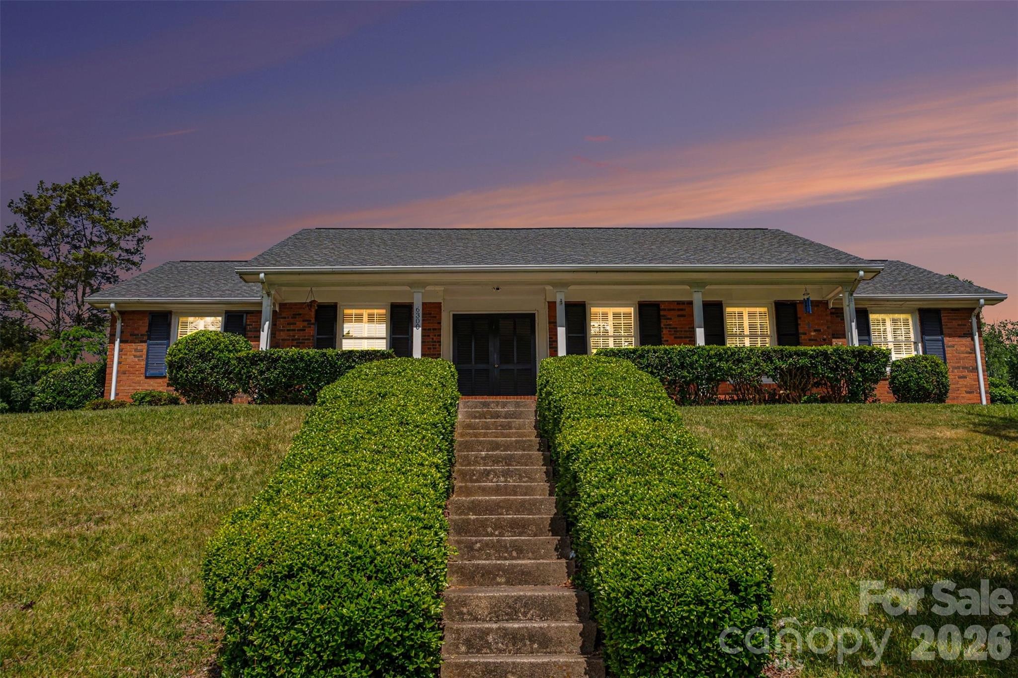 Well-maintained 3BR/2BA ranch home located in an established Charlotte neighborhood. Features include hardwood, tile, and laminate flooring, a spacious living area with fireplace, and a functional floor plan. Kitchen includes dishwasher, washer, dryer, electric cooktop, and disposal. Exterior features include a concrete driveway, storage building, and mature corner lot with convenient access to shopping, dining, and major highways.