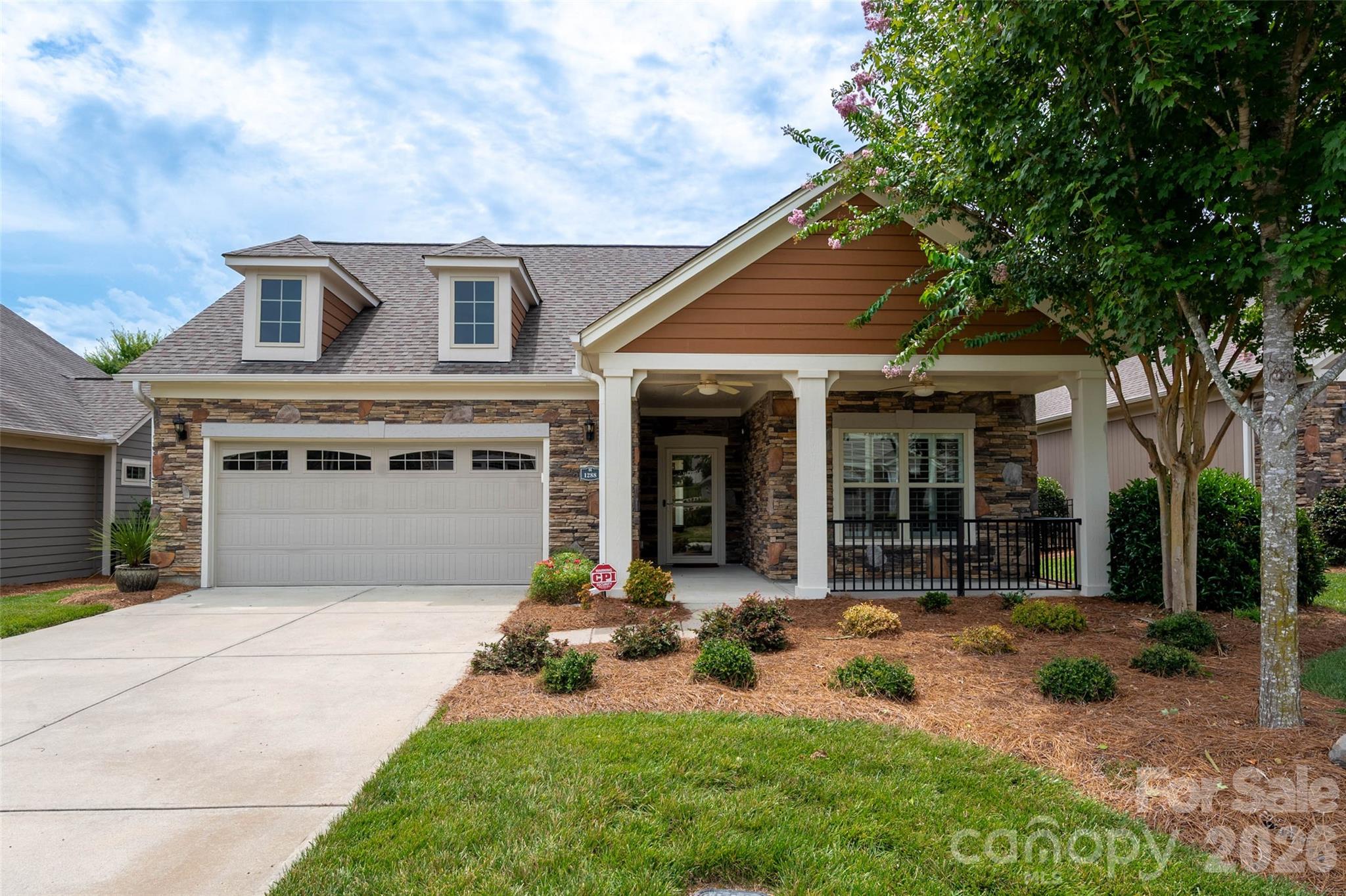 Welcome to this lovely home where you can truly kick back, relax, and enjoy the good life. Located in the welcoming community of The Courtyards of Marvin, this beautiful ranch home blends everyday comfort with a touch of luxury. The bright, open layout is designed for easy living, featuring warm hardwood floors, cozy custom built-ins, and a spacious kitchen with a large central island that is perfect for casual gatherings or quiet mornings. Just off the main area, elegant French doors open to a peaceful den, offering a quiet spot to read, work, or simply unwind.

When it is time to rest, the primary suite serves as your own private, comfortable retreat, while guests will feel right at home in the spacious second bedroom. One of the best features of this home is how easily it flows outside; just step through the glass doors to a lovely covered porch and extended patio made for effortless outdoor lounging. Best of all, you can officially retire your lawnmower. Because the HOA handles all the landscaping and yard work, you get to spend your time doing exactly what you want in a friendly, low-maintenance neighborhood. Enjoy community walking trails, a pond, outdoor pool, and fitness center—comfort, privacy and active living...its all right here!