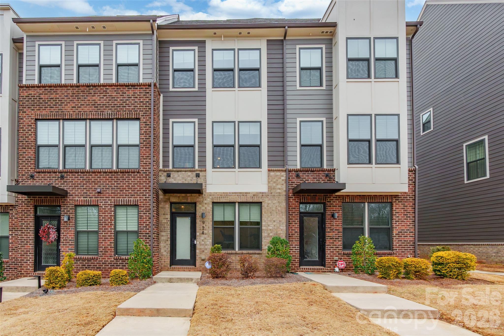 Modern luxury meets unbeatable convenience in this stunning four-story townhome ideally positioned in the heart of Charlotte, just minutes to Uptown, SouthPark, Cotswold, and Plaza Midwood. This is city living without compromise.

The entry level welcomes you with a versatile open space perfect as a home office, gym, or flex space tailored to your lifestyle.

Upstairs, the main living level is filled with natural light and designed for effortless entertaining. The open-concept kitchen flows seamlessly into the spacious family room and dining area, creating a bright and inviting atmosphere. Step out onto your private porch to enjoy morning coffee or unwind with a glass of wine as you take in rare, tree-lined views both in front and behind the home, a true luxury in this prime location.

The top level offers yet another expansive flex space with a full bath attached, making it ideal for a second primary suite, media room, or creative studio. From here, step onto the large rooftop terrace,  your own elevated retreat, perfect for hosting friends, relaxing under the stars, or simply enjoying the peaceful greenery surrounding you.

With modern design, flexible living spaces, and breathtaking views rarely found this close to the city's most sought-after destinations, this exceptional townhome delivers the best of Charlotte living.