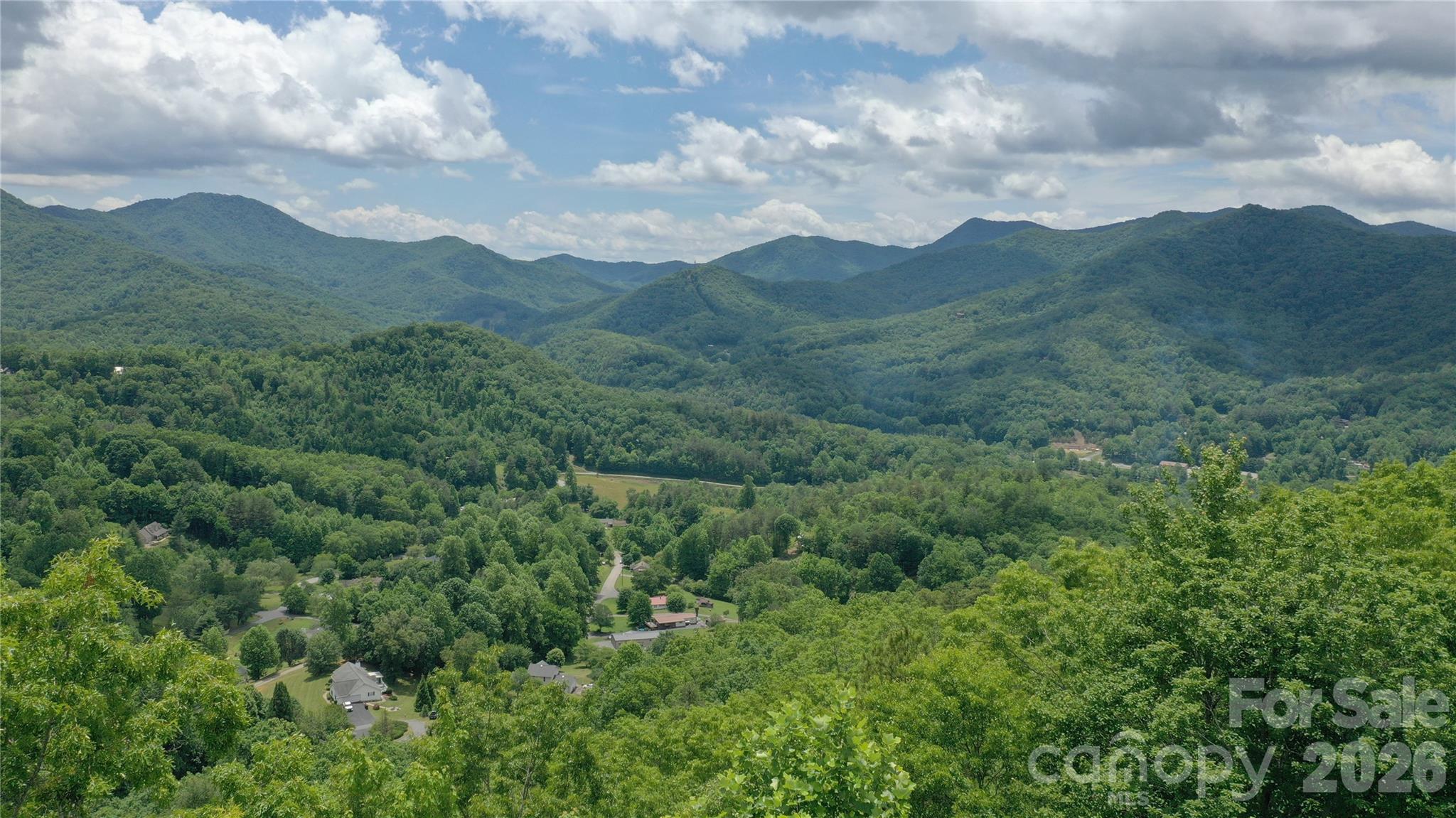 Discover the perfect canvas for your mountain dream home on this stunning ridge line lot at almost 2800 feet in elevation, perfectly positioned to offer breathtaking views of the surrounding scenery. Situated in a prime location, this community provides the ideal balance of secluded mountain living while remaining incredibly close to the charming towns of Dillsboro, Sylva and Franklin, North Carolina. The property comes equipped with excellent infrastructure, featuring community water and underground power already available to protect your pristine vistas. This lot has an expired 3 bedroom septic permit, the groundwork previously laid offers a clear starting point for re-evaluation and development. Vacation rentals are allowed for a potential income producing property. Seller financing is available. Do not miss this exceptional opportunity to own a piece of Western North Carolina's natural beauty with convenient access to local shopping, dining, and outdoor recreation.