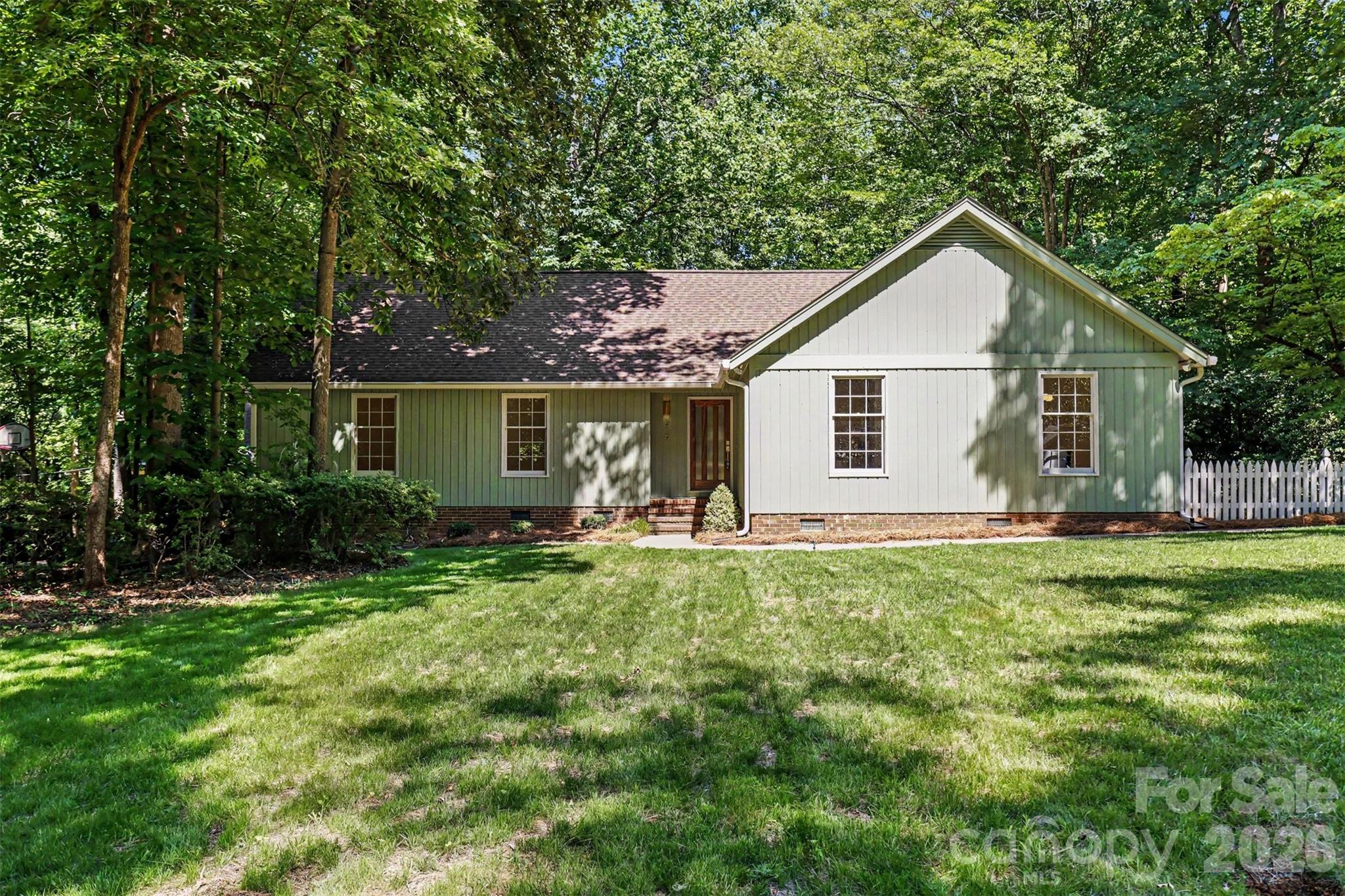 Step into a home that has been transformed from its 1980s roots into a stylish, modern retreat. This beautifully renovated 3-bedroom, 2-bath ranch home features fresh interior and exterior paint, new LVP flooring, and new tile in the primary suite bathroom. The inviting floor plan offers a spacious living and dining area that flows into the remodeled kitchen, complete with new cabinetry, quartz countertops, tile backsplash, new appliances, and a pantry for extra storage. A cozy breakfast nook provides the perfect space for a coffee bar, dry bar, or casual dining area. Adding to the home's appeal is a comfortable den anchored by an original rock fireplace, offering warmth and character. Sliding glass doors lead to an expansive deck overlooking a peaceful, wooded backyard, creating a seamless indoor-outdoor living experience. The spacious primary suite features a beautifully updated ensuite bath, flex space ideal for a sitting area or home office, and private access to the deck and outdoor seating area. Two additional bedrooms and a renovated full bath complete the home. Located on a quiet cul-de-sac in an established neighborhood with mature trees, this move-in-ready home perfectly blends modern updates with timeless charm and original character. Agent is owner of the property.