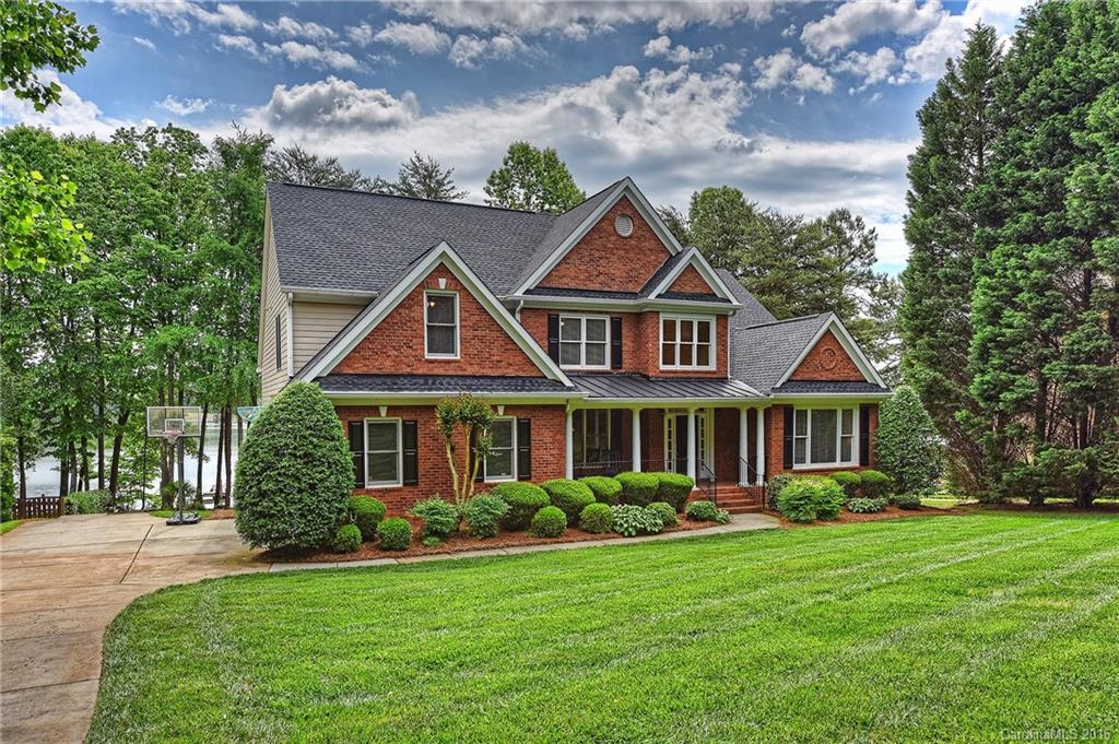 Enjoy lake living at its finest in this incredible waterfront retreat. The home presents a sandy beach, pier with private boatslip, & an abundance of outdoor entertaining space.  The main level has a desirable open floorplan including the Mstr Bd & a Guest Ste. The considerable Great Rm has a grand feel with a soaring two story ceiling & built-ins. Many recent updates including new hardwood floors, new kitchen appliances, & new carpet throughout. All bedrooms provide access to a private bath.