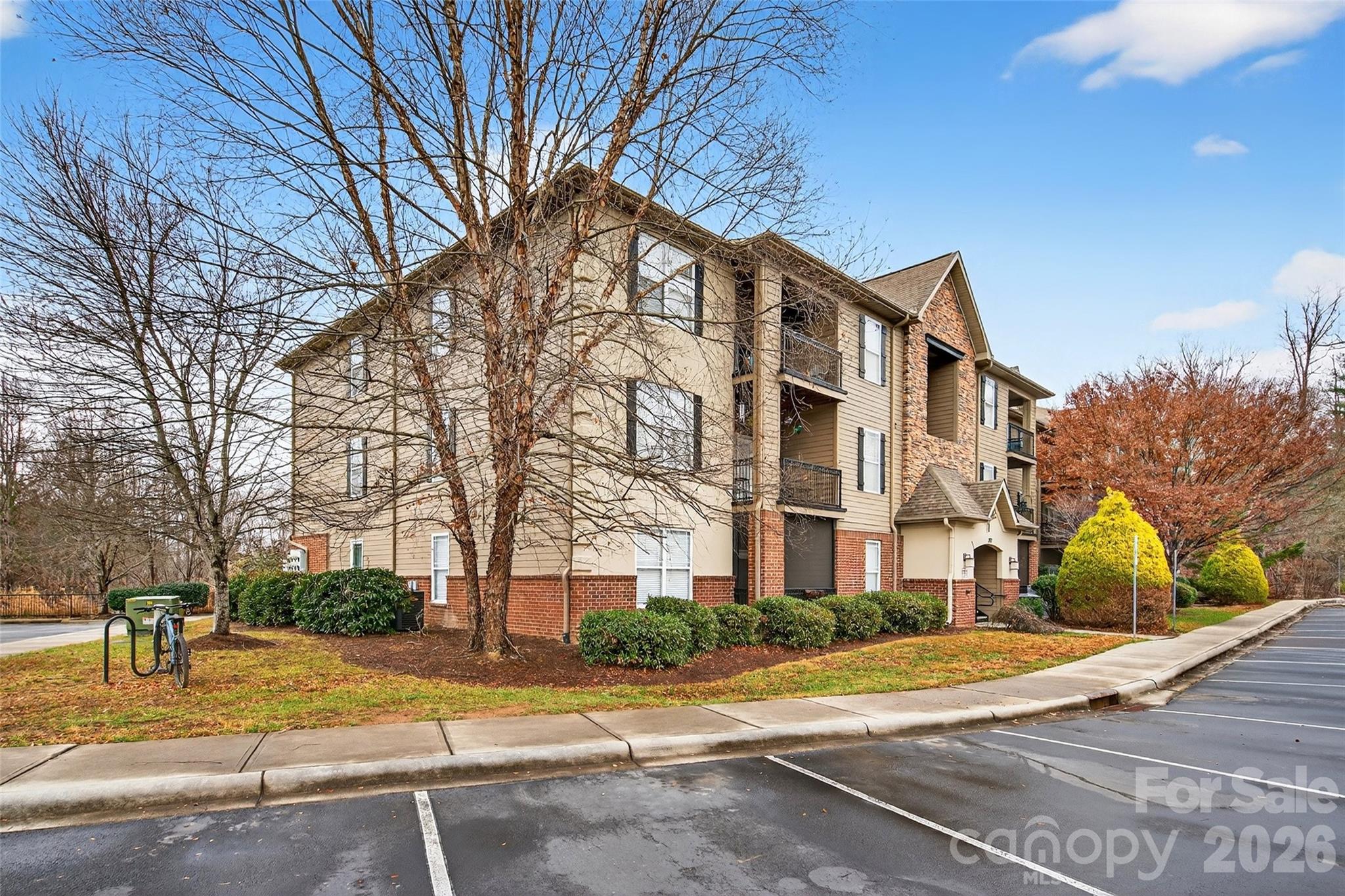 Located in the highly desirable Brickton Village community, this immaculate 3 bedroom, 2 bathroom condo offers a bright, open floor plan and low maintenance living. The spacious layout includes a private primary suite with an ensuite bath, an in unit laundry room and a mix of wood, tile, and carpet flooring. A wall mounted Murphy bed adds versatility for guests and conveys with the sale. The living area opens to a private patio, perfect for relaxing or enjoying indoor-outdoor living. Recent upgrades include a new washer, refrigerator, and hot water heater, providing peace of mind and added value. Brickton Village residents enjoy beautifully maintained grounds, a fenced dog park, picnic areas with grills, and scenic walking trails, all within a quiet, tranquil setting. This prime location is just minutes to I-26, and a short drive to Asheville, Hendersonville, and Asheville Regional Airport, offering unmatched convenience for commuting, travel, shopping, and dining. A rare opportunity to own in one of the area’s most convenient and well kept communities.