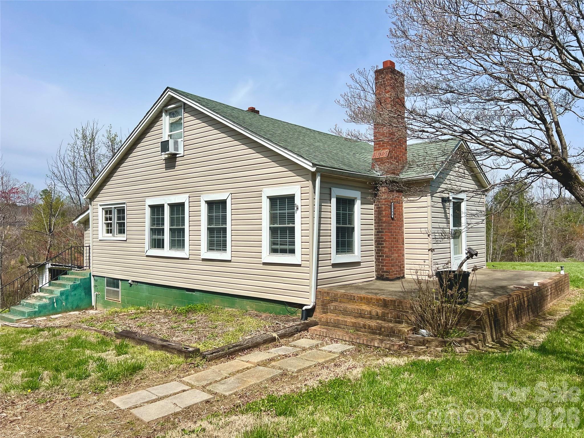Endless Opportunities! This 3 bed 2 bath home features plenty of options, sitting on over two acres! Convenient floorpan with two bedrooms downstairs, and a large bedroom upstairs that could also be used as a den area, office, play room, etc. with a full bath up there as well. A great opportunity to have a property with more land right in Hickory. Positioned along NC Highway 10, this home offers convenient access to shopping, dining, and major routes around Hickory. The lot has mature blueberry bushes, and is perfect for gardening. The home could use a little bit of TLC, like a fresh coat of paint, and it will be perfect for someone!