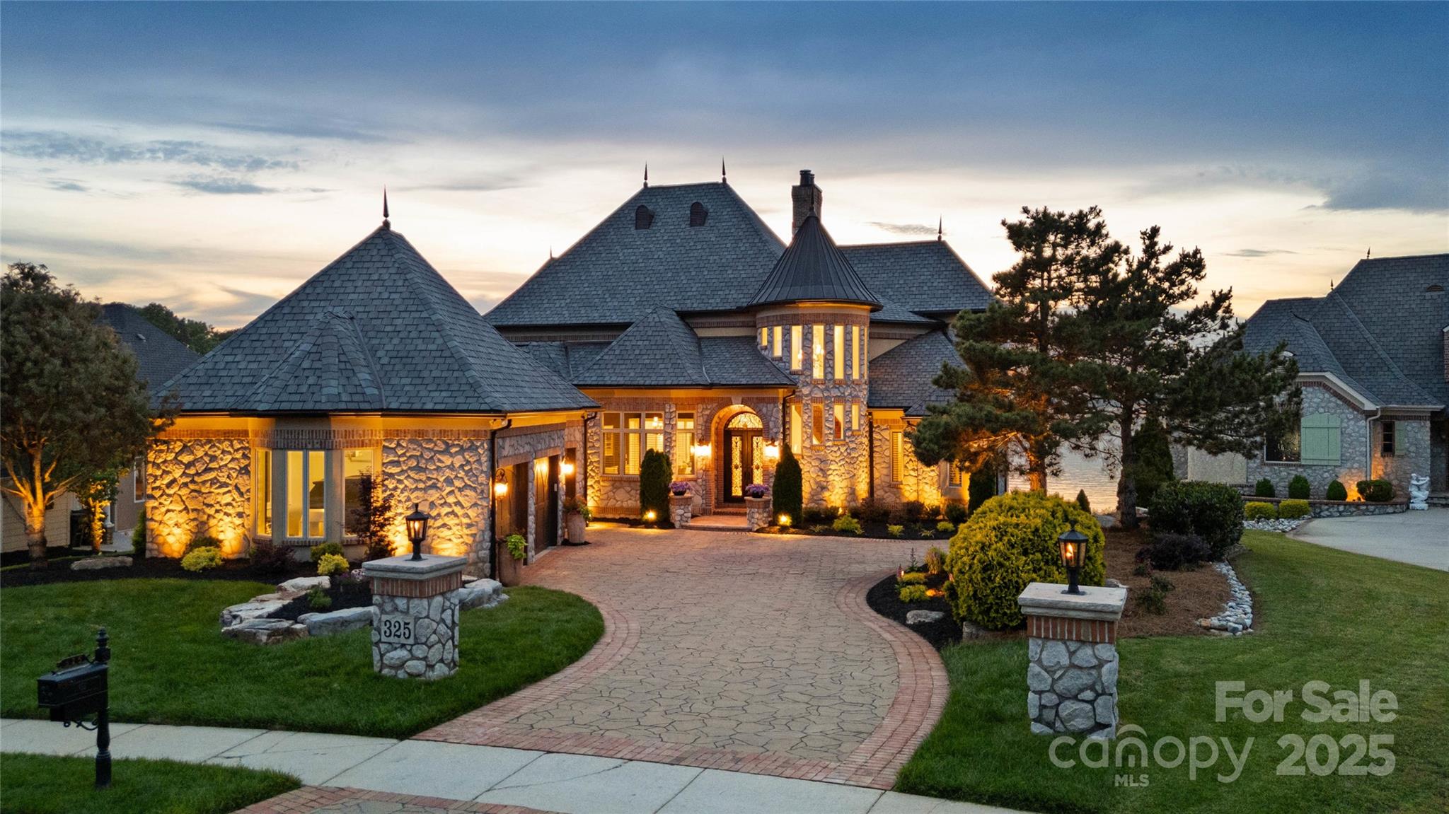 Experience unparalleled luxury in this breathtaking custom waterfront estate on Lake Wylie, nestled in the exclusive gated community of Joslin Pointe. Showcasing rare panoramic main channel views, this European-inspired brick and stone masterpiece offers over-the-top elegance w/ a soaring two-story great room, a remodeled chef’s kitchen featuring Viking appliances, custom cabinetry, quartz countertops, and upscale finishes throughout. The main-level primary suite features porch access w/ water views and a marble spa bath w/ dual vanities, soaking tub, walk-in shower, and dual custom closets. Entertain on three levels w/ endless amenities including, wet bar, climate-controlled wine cellar, full basement bar, movie theater, and billiard room. Outside, relax or entertain with picturesque sunset views, gas firepit, outdoor kitchen, Trex Dock with covered boat slip w/ remote controlled 9,000lb lift, 2 wave runner lifts and sun-bathing area. This estate defines luxury lake lifestyle living!