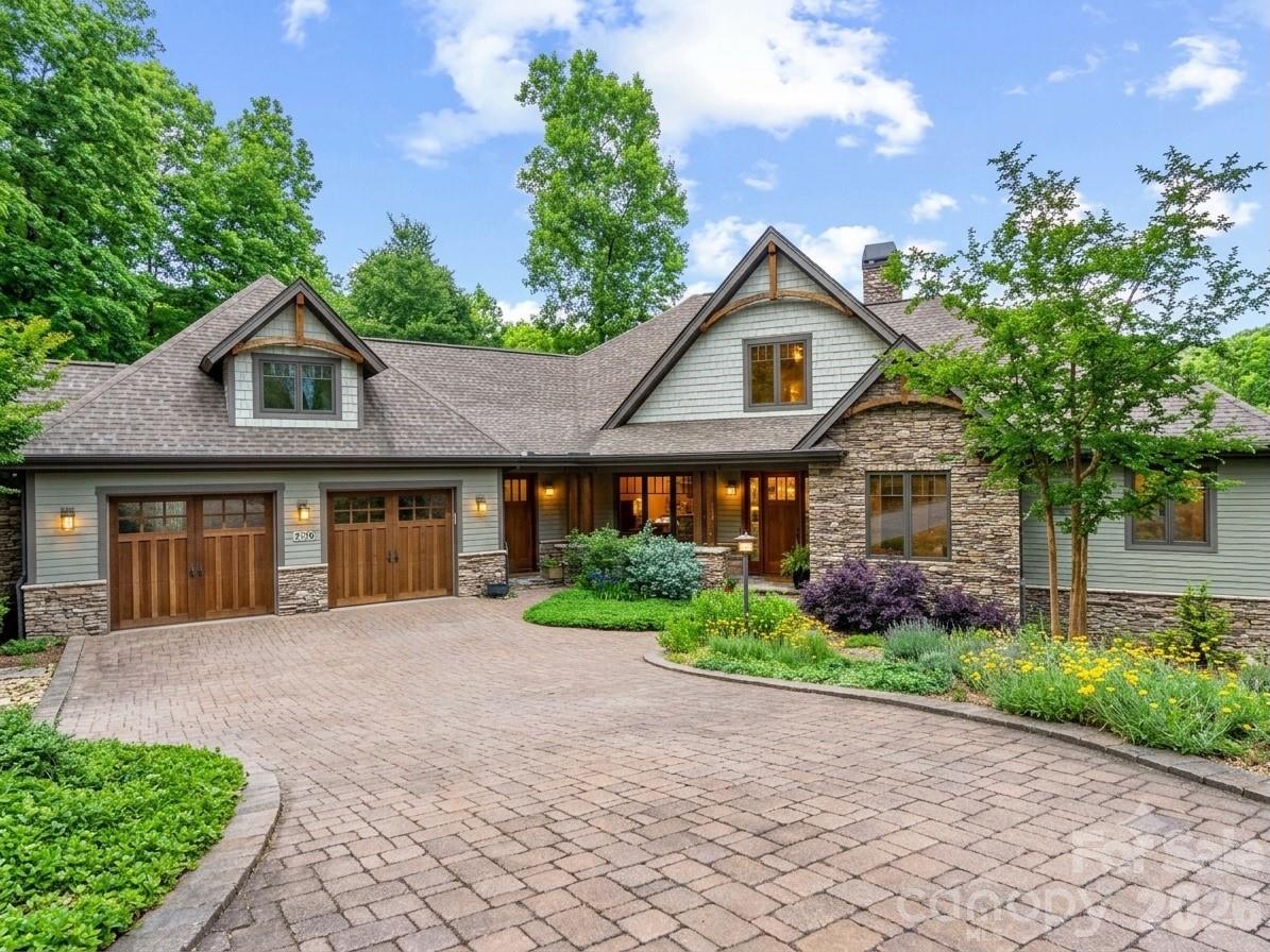 Nestled at the end of a quiet cul-de-sac in the premier gated community of Oleta Falls in Hendersonville, NC, this custom Arts & Crafts Masterpiece offers a rare blend of luxury, privacy, and natural beauty. Inside, an open-concept floor plan showcases vaulted ceilings, exposed timber beams, and rich Oak and Knotty Alder millwork. The main level features a chef’s kitchen, a sunroom, a dedicated study with a vaulted wood ceiling, and a primary suite with mountain views, deck access, and dual walk-in closets.

The fully finished lower level is built for entertaining, boasting two additional en-suite bedrooms, a spacious family room with a fireplace and custom bar, a gym/flex room, a workshop, and a garden shed. Premium upgrades abound, including a whole-house generator, 3-zone geothermal HVAC, 10-foot solid doors, high-speed internet, and a direct interior staircase from the oversized 2-car garage to the basement.

Enjoy exceptional outdoor living on the upper deck or lower stone patio, surrounded by terraced gardens and seasonal mountain views. Residents enjoy access to Oleta Falls’ private 40-foot waterfall, miles of hiking trails, and a lodge-style clubhouse with a pool. Bonus: An adjacent 1.35-acre homesite is also available for ultimate privacy or expansion!