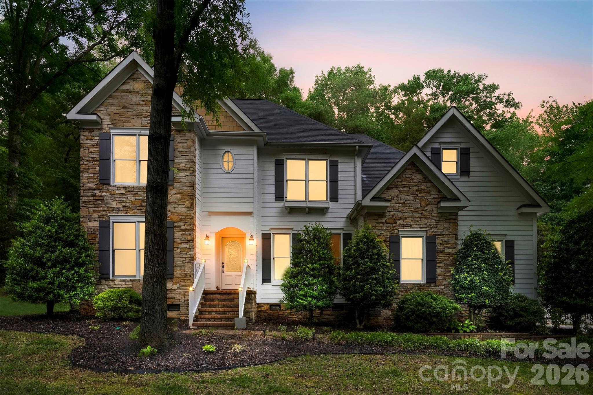 Tucked away on a beautifully wooded .67-acre lot in the desirable North Lake community, 10112 Windtree Lane offers the perfect blend of privacy, comfort, and convenience. Meticulously maintained with fresh updates throughout, this home features 3 bedrooms, 3 full baths, a large bonus room, and a versatile main-level office/flex space ideal for guests or working from home. 
The thoughtfully designed layout features hardwood flooring throughout the main level, abundant natural light, and seamless flow between living spaces. The kitchen offers custom countertops, tile backsplash, ample cabinetry, and a generous pantry, all opening to the inviting great room with a striking stone gas fireplace.
The spacious primary suite includes a sitting area, walk-in closet, and spa-like bath with custom tile details and a soaking tub. Upstairs, the oversized bonus room provides flexible space for a media room, playroom, fitness area, or additional living space.
Enjoy peaceful backyard views from the covered rear porch, perfect for relaxing or entertaining. Additional highlights include a side-load 2-car garage, storage building, a playset and convenient access to I-485, shopping, dining, hospitals, and Uptown Charlotte. The seller is highly motivated and has thoughtfully positioned this home to offer exceptional value in today's market.
Recent updates include a garage door motor (2026), preventative termite bond with Killingsworth (2026), new electric range top (2025), built-in office cabinetry (2025), updated lighting (2025), a new roof (2024), interior repaint (2024), updated pantry and laundry room (2024), well pump replacement (2024), septic pump service (2024), and a fully encapsulated crawl space with sump pump (2021). We are excited for you to see this home!!