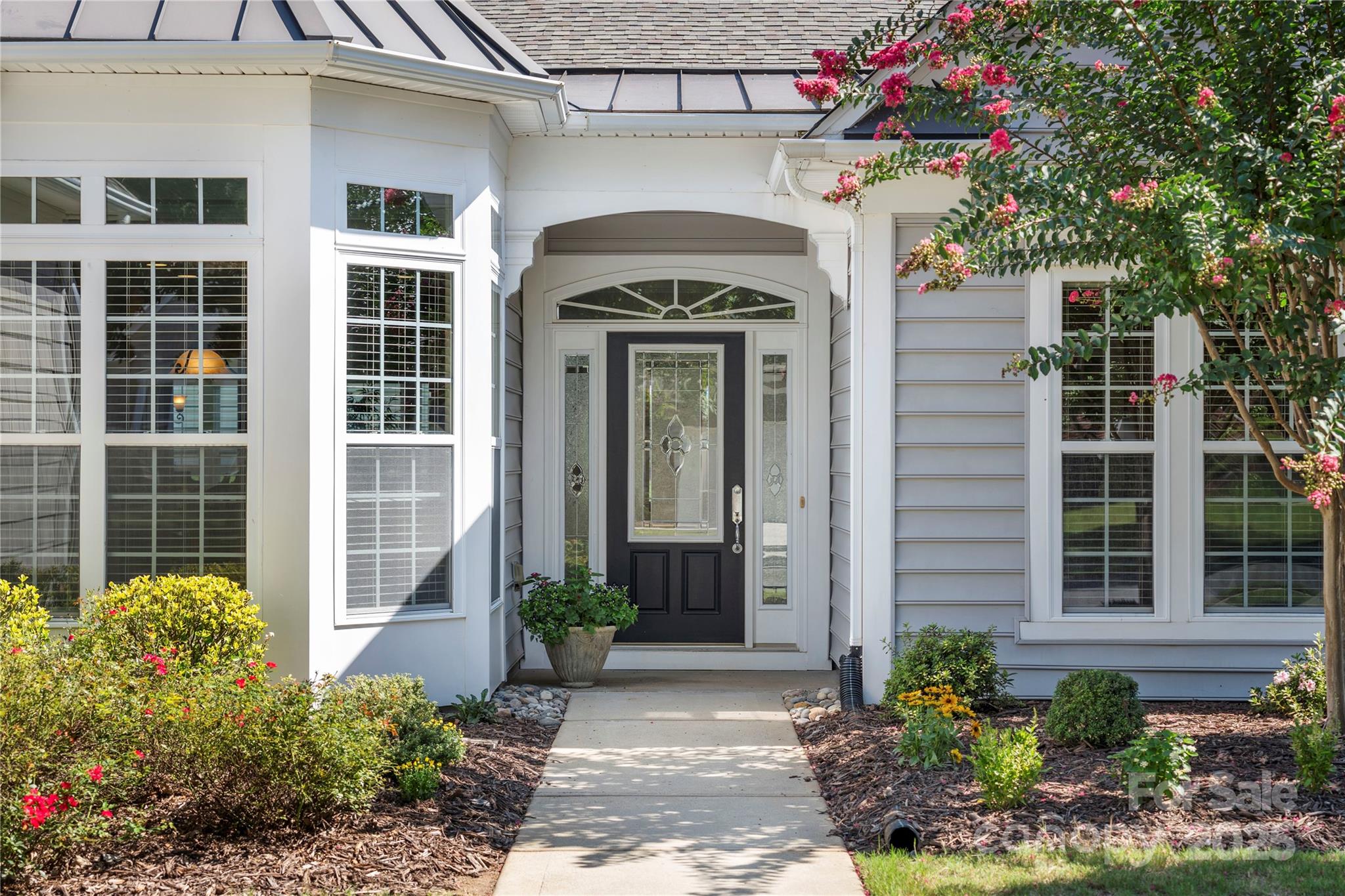 Nestled on the corner of a serene, tree-canopied street and a quiet cul-de-sac, this beautifully maintained home offers a welcoming exterior and a prime location within Sun City Carolina Lakes.  Inside, an open and thoughtfully designed floor plan flows from room to room, designed for comfortable, casual living.  A dedicated home office or craft room off the foyer provides space that can be tailored to your needs.  The kitchen features ample cabinetry, generous counter space, and an island perfect for meal prep. The sunroom invites you to unwind in a bright and cozy setting where sunlight streams through surrounding windows. Step outside to a well-designed paver patio—ideal for morning coffee or evening drinks. Two guest bedrooms, each with walk-in closets, are connected by a stylish Jack-and-Jill bathroom complete with an updated walk-in shower. On the opposite side of the home, the newly carpeted primary suite offers a tranquil retreat with a spacious walk-in closet, soaking tub, and an updated walk-in shower.  Additional features include an epoxy-coated garage floor, a built-in drop zone, and a well-equipped laundry room with cabinetry and a utility sink.  Located in a vibrant, 55+ active adult community with frequent community events and a warm, social atmosphere—this home is a true gem for those seeking convenience, and connection.