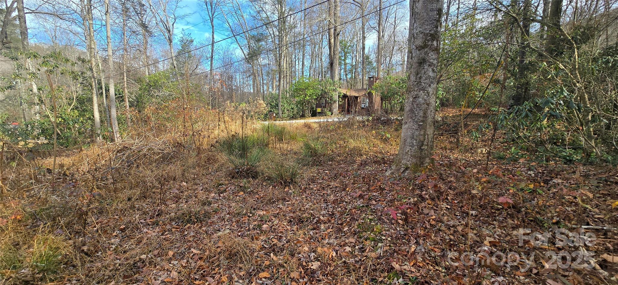 An almost level home site located just minutes from the heart of Maggie Valley! With access to city water & sewer, it makes for a very easy build! The year-round access is easy with gentle, wide paved roads. There is electricity to the lot along with wired cable/internet. Located in the Twin Brooks Resort Community, lot owners will have access to the amenities that include the indoor pool, clubhouse, playground, and common area. There is a 1000 square foot minimum home size. A rare opportunity in Maggie Valley to get a nearly level lot with easy, paved access, & water & sewer! HOA dues are $1200 per year, which cover the road maintenance, pool & amenities, and exterior grounds maintenance. Nice flowing creek at the back of the property.