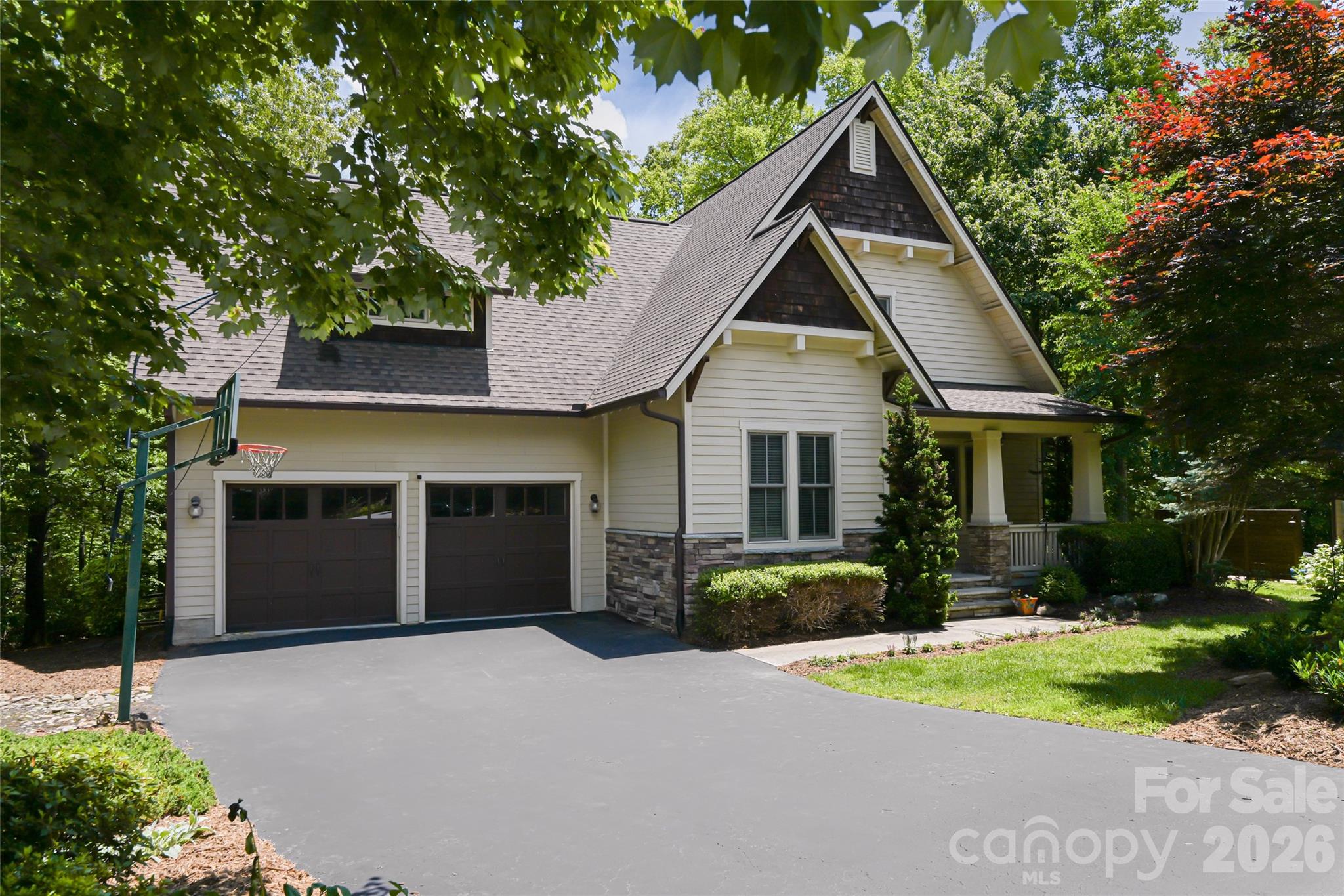 Tucked within the prestigious gated community of Southcliff, 1 East Owl Creek Lane offers an exceptional blend of luxury, privacy, and natural beauty. Set on a serene wooded lot at the end of a quiet cul-de-sac, this thoughtfully designed custom home showcases refined mountain living at its finest.

Filled with natural light, the open-concept floor plan creates an effortless flow between the living, dining, and entertaining spaces, extending seamlessly onto a screened porch ideal for gathering with family and friends. Start your mornings with coffee on the expansive deck, surrounded by the peaceful sights and sounds of the mountains. Spacious guest accommodations provide comfort and privacy for visitors, making the home equally suited for everyday living and hosting.

With access to miles of scenic hiking trails and just minutes from downtown Asheville, this home offers the perfect balance of tranquility, convenience, and elevated Blue Ridge Mountain living.
