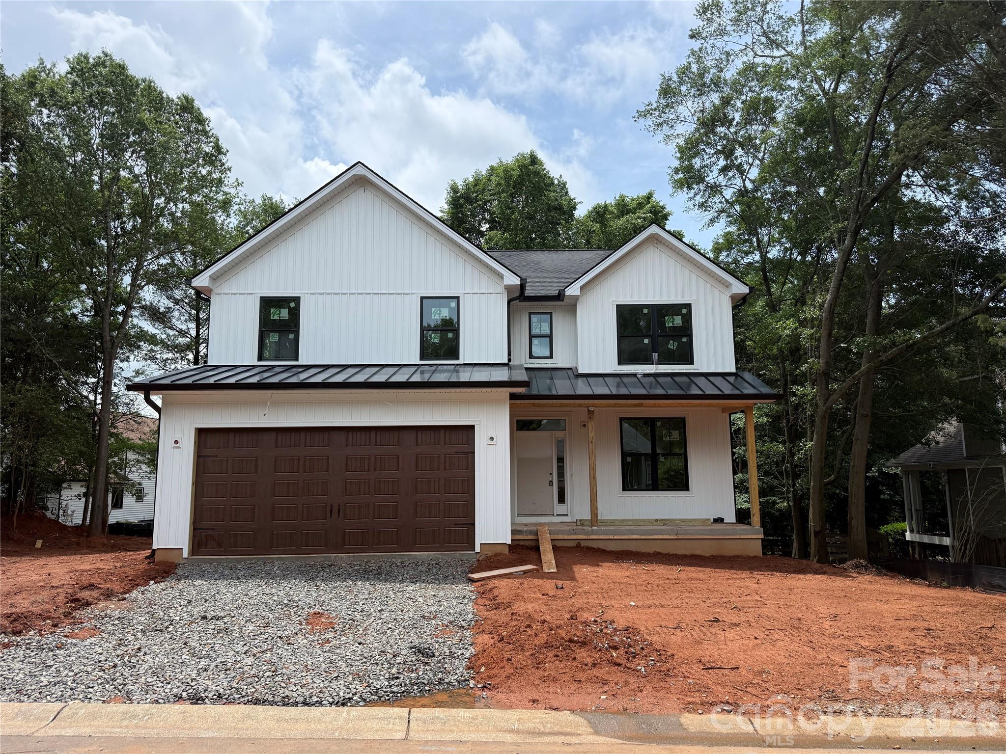 New Construction located in Tega Cay on the peninsula. White Vinyl siding with black windows. Wood accents in roof gables and porch ceiling. 4 Bedrooms, 2.5 Baths with an upstairs laundry room. Main floor features kitchen with walk in pantry, fireplace in living room, and drop zone. Basement is unfinished, conditioned and has a full bathroom rough-in. Professional Landscaped. Fort Mill Schools. No HOA.