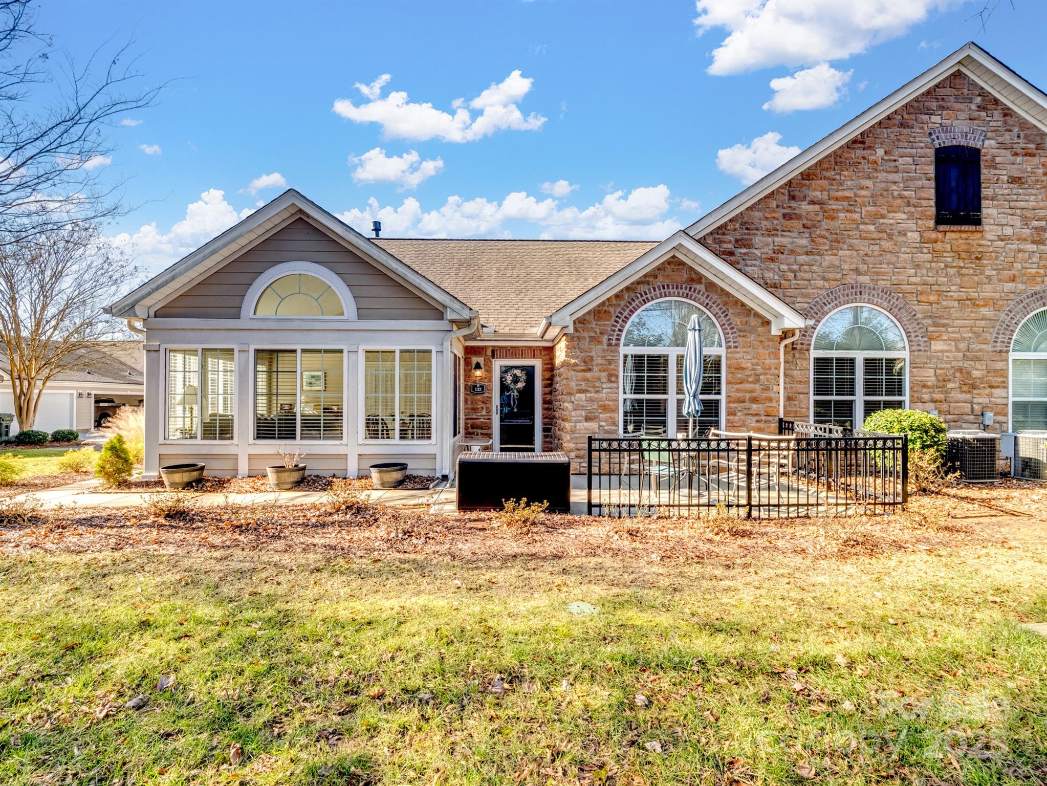 Welcome to this beautifully upgraded patio home in the sought-after 55+ community of The Village at India Hook in Rock Hill, SC! Featuring 3 bedrooms and 2 full bathrooms, this home boasts an open-concept design that effortlessly connects the kitchen, dining, and living areas—perfect for hosting friends or enjoying a quiet evening at home. The kitchen is a standout with taller cabinets for extra storage, granite counter tops, and a gas stove. Additional upgrades include extra closet space throughout, making organization a breeze.

Relax by the cozy gas fireplace or unwind in the bright and cheerful sunroom, a perfect retreat for any time of year. The spacious 2-car garage provides ample room for parking and storage.

Community amenities include a clubhouse with a fitness center, meeting area, and a sparkling pool. Conveniently located near shopping, grocery stores, and everyday essentials, this home offers the perfect blend of comfort and convenience.