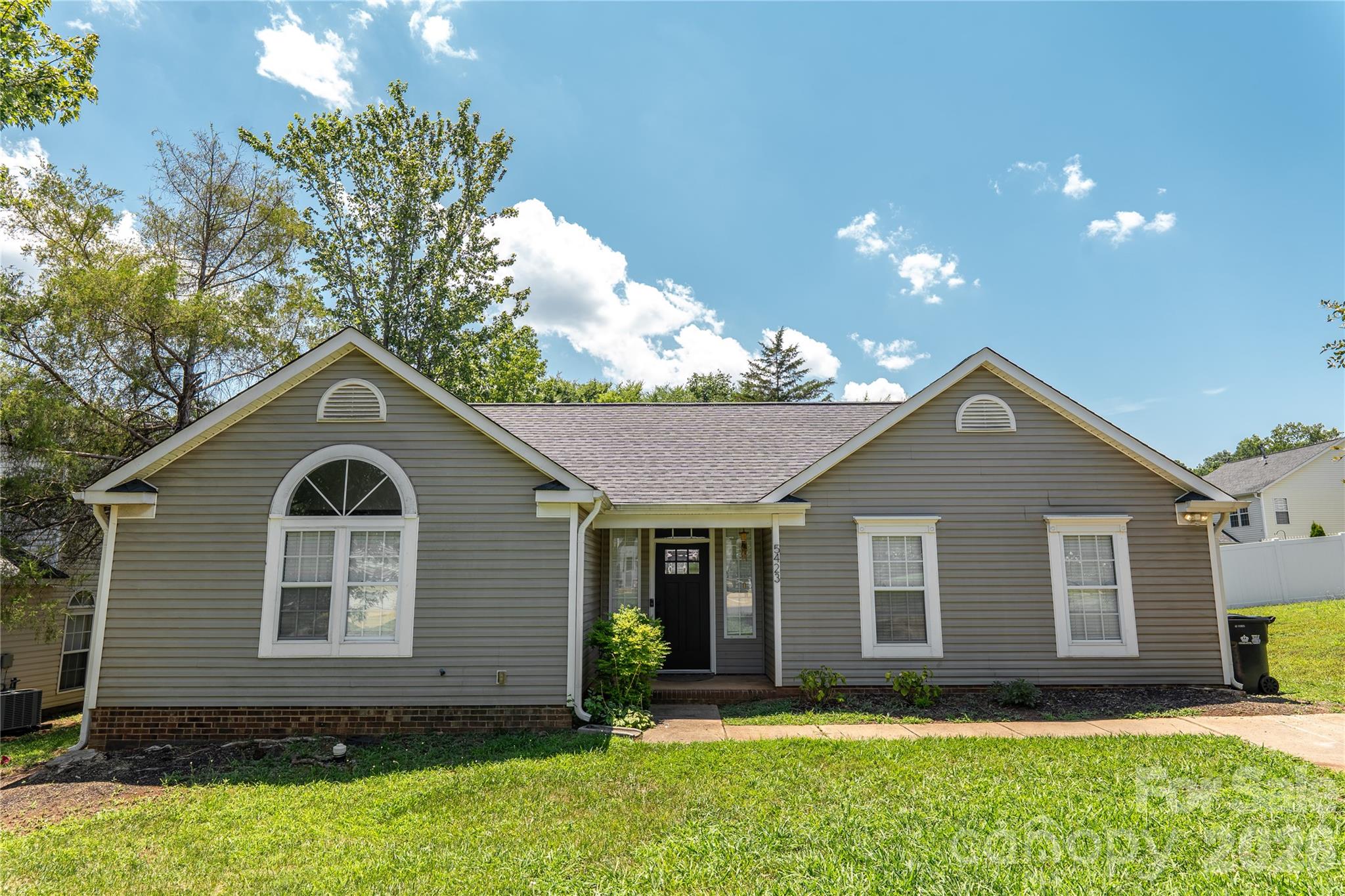 Move-in ready 3-bedroom, 2-bath home in Charlotte featuring bright interior spaces, and valuable recent updates. The home includes a newer roof, a whole-home water filtration system, repaired windows, and one room updated from carpet to vinyl flooring for a clean, low-maintenance finish. The kitchen includes major appliances, including the refrigerator, stovetop, and microwave. Washer and dryer are also included. The fenced backyard provides added privacy and outdoor usability.