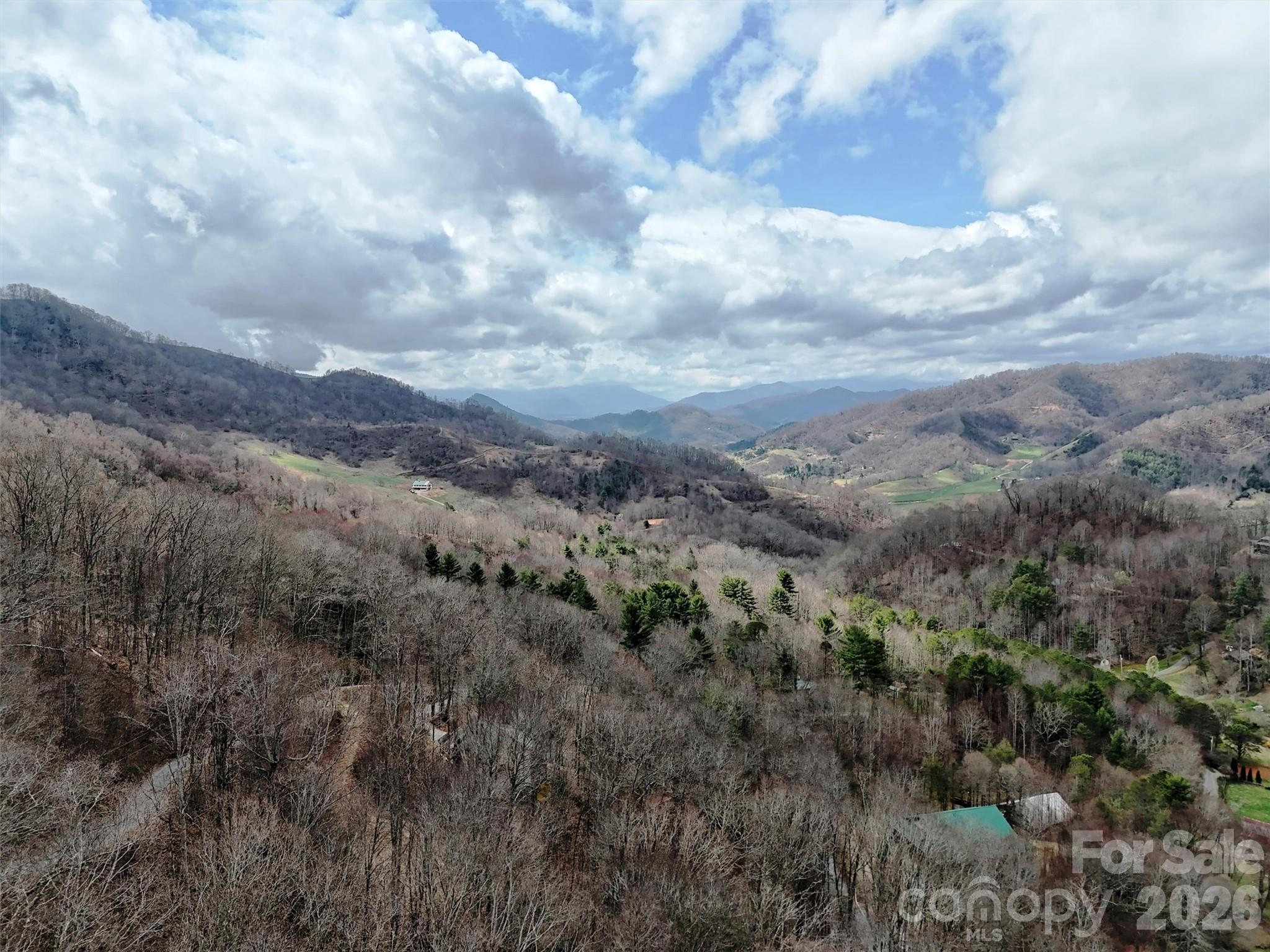 Tucked away in the desirable Hidden Valley community of Crabtree, these two adjoining lots offer a combined 3.21 acres of beautiful mountain land ready for your dream home or mountain getaway. Both lots have previously perked for septic systems and passed inspection, though permits have expired. Enjoy stunning long-range mountain views, privacy, and the peaceful setting that makes Western North Carolina so special. With plenty of room to build and explore, this property offers an incredible value in a scenic and sought-after location. A rare opportunity to own beautiful acreage with excellent potential in the heart of Crabtree.