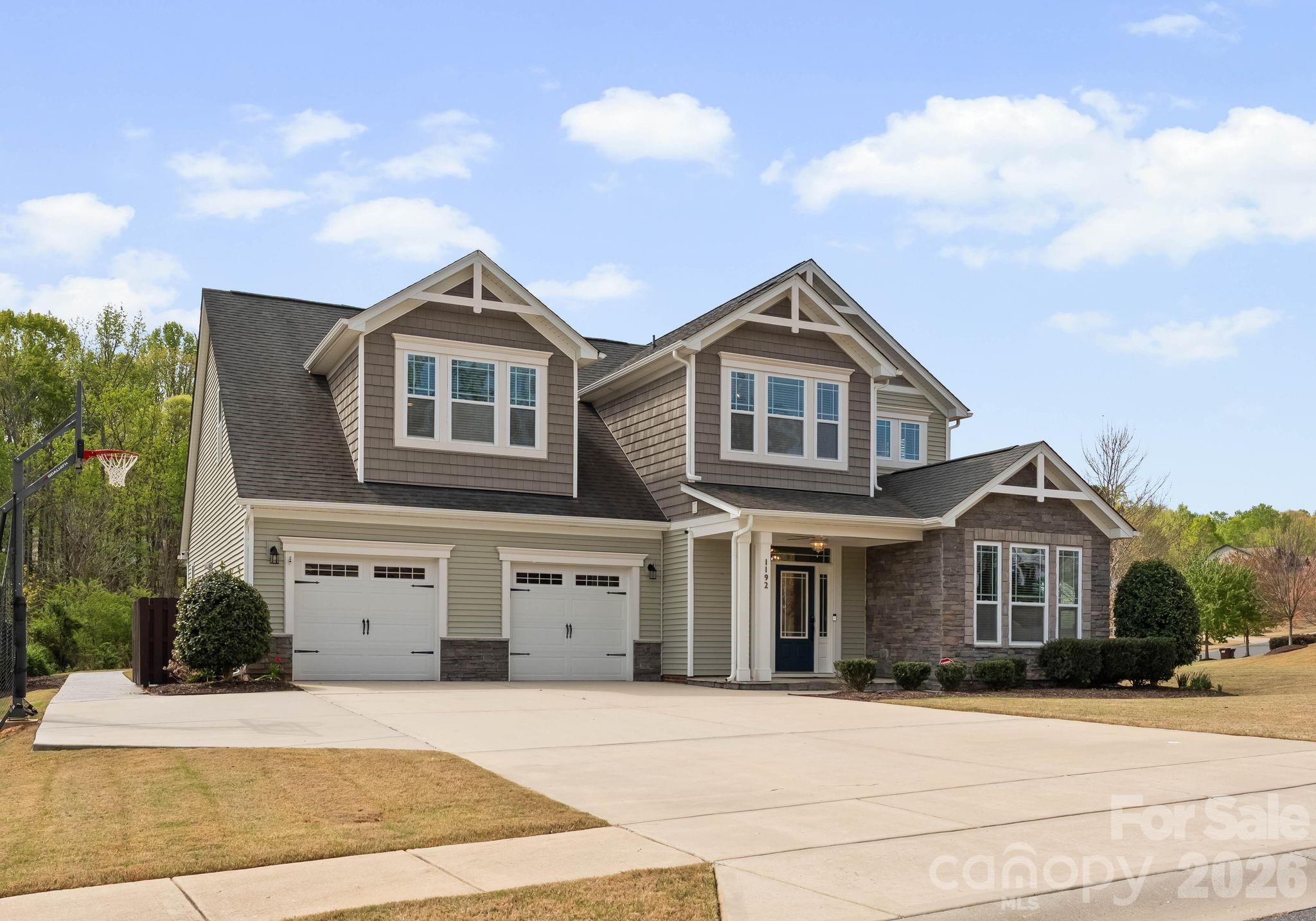 Tucked on a spacious .45-acre homesite in the Shelly Woods community, this 4-bedroom, 3.5-bath home offers 3,348 square feet of thoughtfully designed living space with a layout that blends comfort and functionality. The main level features a private primary suite and a dedicated office or flex space accented with detailed trim work, while the open-concept great room with gas fireplace flows seamlessly into the kitchen and dining area—ideal for everyday living and entertaining. The kitchen is equipped with granite countertops, a large center island, stainless steel appliances, wall oven, and an apron-front sink for a clean, updated look.
Upstairs, you’ll find three additional bedrooms, including a Jack-and-Jill bath with dual vanity, along with a spacious bonus room complete with a wet bar and wine fridge—perfect for a media room or entertaining space.
Step outside to enjoy the fully fenced backyard featuring a large paver patio with pergola, hot tub, and storage shed, offering both privacy and functionality. Additional highlights include an irrigation system, epoxy-coated garage floor, wide driveway, and abundant storage throughout.
Shelly Woods residents enjoy access to a community pool and playground, all conveniently located near shopping, dining, and major commuter routes.