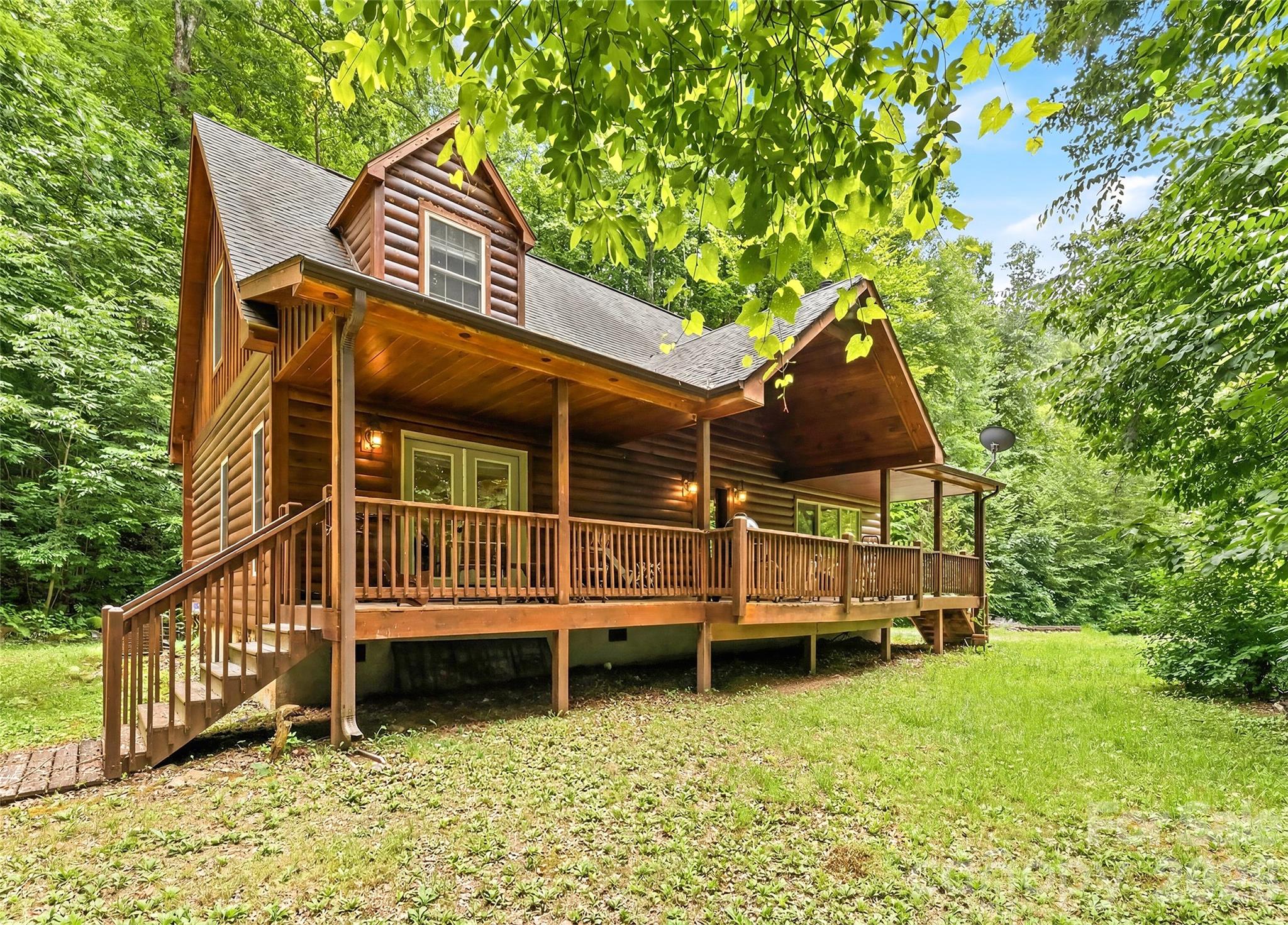 Nestled in the heart of nature, this charming 3-bed, 3-bath home delivers the warmth and character of mountain living with over 2,000 sqft of quality craftsmanship. Step onto the private front porch for a quiet morning coffee or an evening watching the fireflies. The main level shines with beautiful hickory floors, a cozy living room anchored by a stacked stone wood-burning fireplace, and a well-appointed kitchen featuring hickory cabinet and stainless-steel appliances. The main level primary suite is a true retreat with a jacuzzi tub and private double doors opening to the porch. A second bedroom or office and full bath complete the main floor. Upstairs delivers a pleasant surprise — a spacious family room or den, third bedroom, and full bath. Outside, freshly painted log siding (2025), a garden shed, storage shed, and new HVAC (2025-main level) round out this move-in ready mountain home. Conveniently located with easy access to Dillsboro, Sylva, and Franklin — the best of WNC is right at your doorstep.