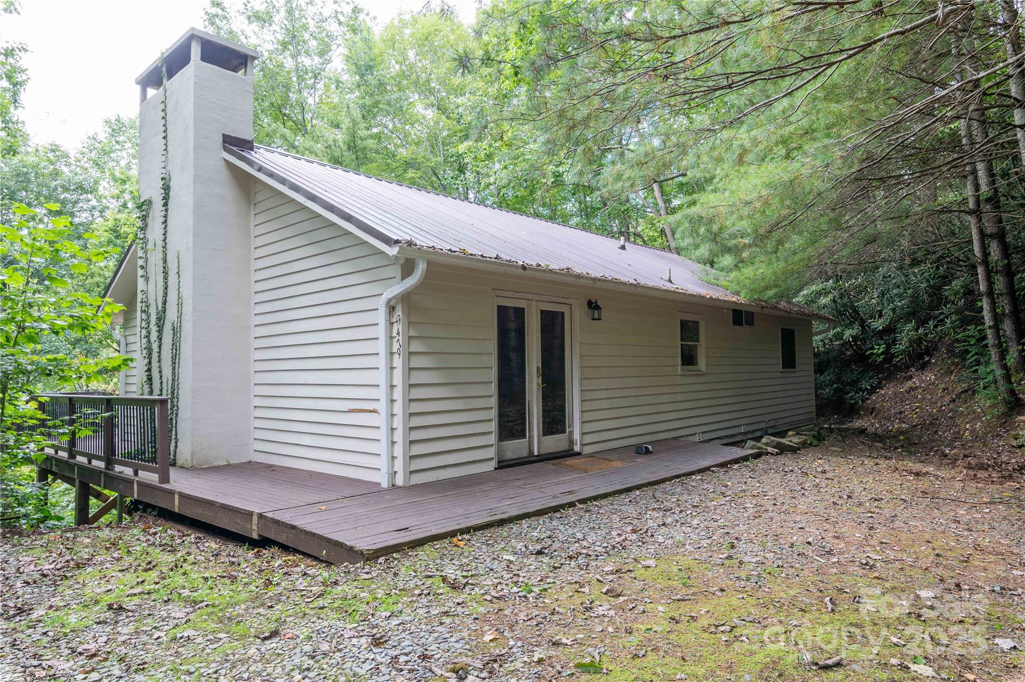 Nestled within a serene golf course community and surrounded by the pristine wilderness of the Pisgah National Forest, this exceptional 3-bedroom, 2-bathroom home offers a blend of seclusion and outdoor adventure. This isn't just a house; it's a gateway to an unparalleled lifestyle and an investment opportunity. Situated on nearly two acres of private, usable land, this property allows  peace and tranquility. Enjoy isolation from neighbors while being just minutes from community amenities. Wake up to breathtaking views and the gentle sounds of nature, with frequent sightings of deer, wild turkey, and songbirds right from your windows.  A downstairs large, open-concept family and game room provides the perfect space for a pool table, home theater, or a second living area—ideal for hosting guests or enjoying family game nights. The main living area features a warm and inviting atmosphere, a well-appointed kitchen, and three generous bedrooms, including a primary suite for rest and relaxation.  An Outdoor Enthusiast's Paradise: step outside your door into a world of adventure with fantastic fishing in the renowned South Toe River, and direct access to national park trails where you can hike, mountain bike, and explore acres of protected wilderness right from your backyard.  And with the Mount Mitchell Golf Course “in the neighborhood”, your days of leisure on the greens are just down the street. Positioned approximately an hour from the high-class amenities and cultural scenes of Asheville, Boone, and Blowing Rock, the central location makes it a short trip to amazing food and entertainment.  This home is also a proven performer for both short-term and long-term leases, capitalizing on its desirable location near national parks and fishing hot spots. It represents a fantastic opportunity for passive income.  Priced to sell, so come take a look before it’s gone!