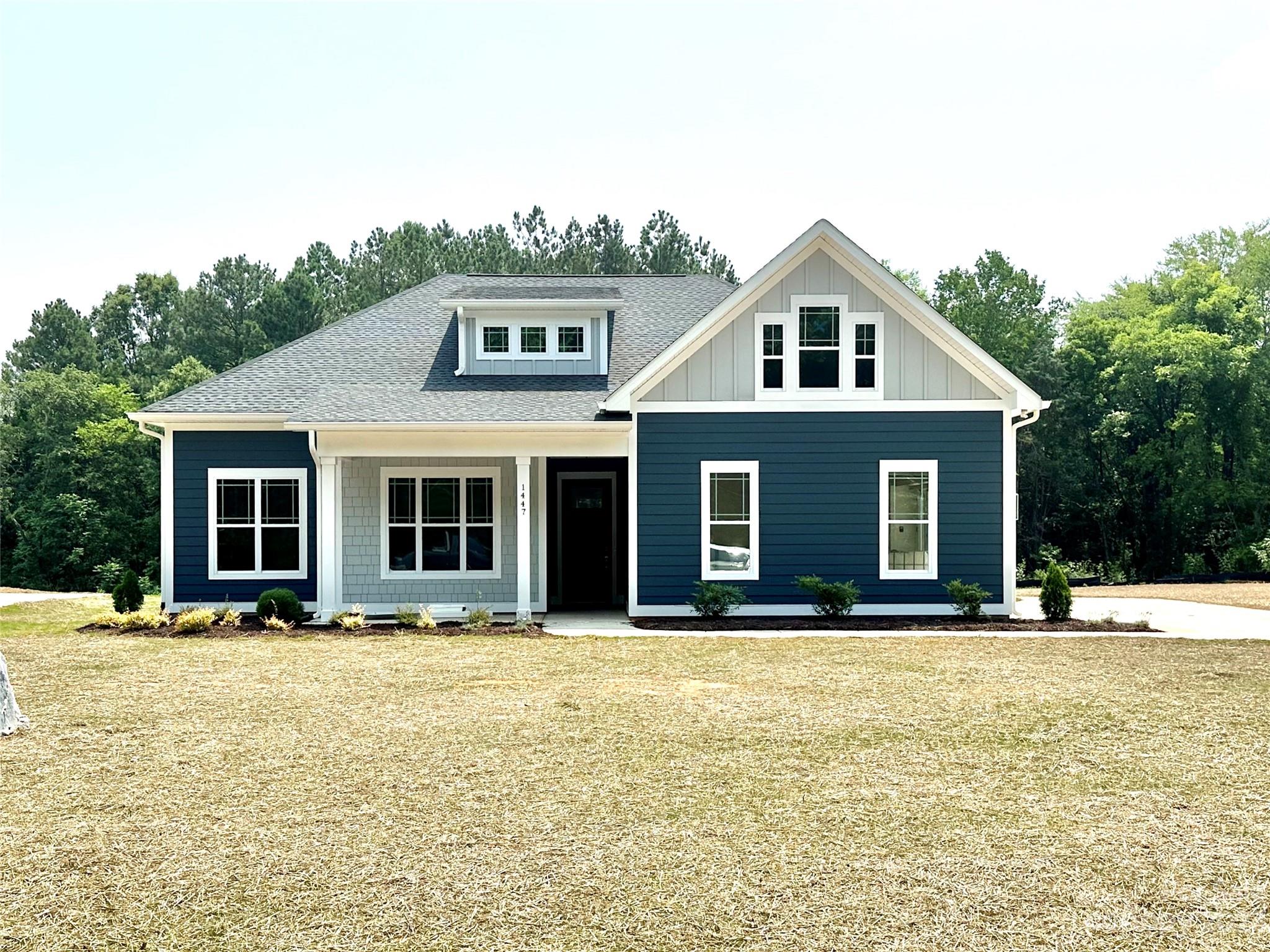 Don't miss your chance to get into this gorgeous new construction by custom home builder Tom Ras. The Sunny plan will feel like home with its welcoming covered front porch and solid wood craftsman front door. High ceilings, tall baseboards & wood flooring are just some of the details that will get your attention! Situated on a 1.03 acre lot, you have plenty of room to enjoy the setting. This open concept offers a primary suite on the main level with custom closet systems, trey ceiling and a beautiful spa like bath. You'll find 2 more bedrooms on the main level as well. All of the bathrooms have quartz countertops, tile bath or shower and custom lighting. Your great room has a coffered ceiling, fireplace, and built-ins that can be enjoyed from the kitchen as well. The kitchen has grey cabinets, large center island, stainless steel appliances, quartz countertops, under cabinet lighting and recessed lighting. Enjoy the evenings from your covered patio. Just minutes from the University!