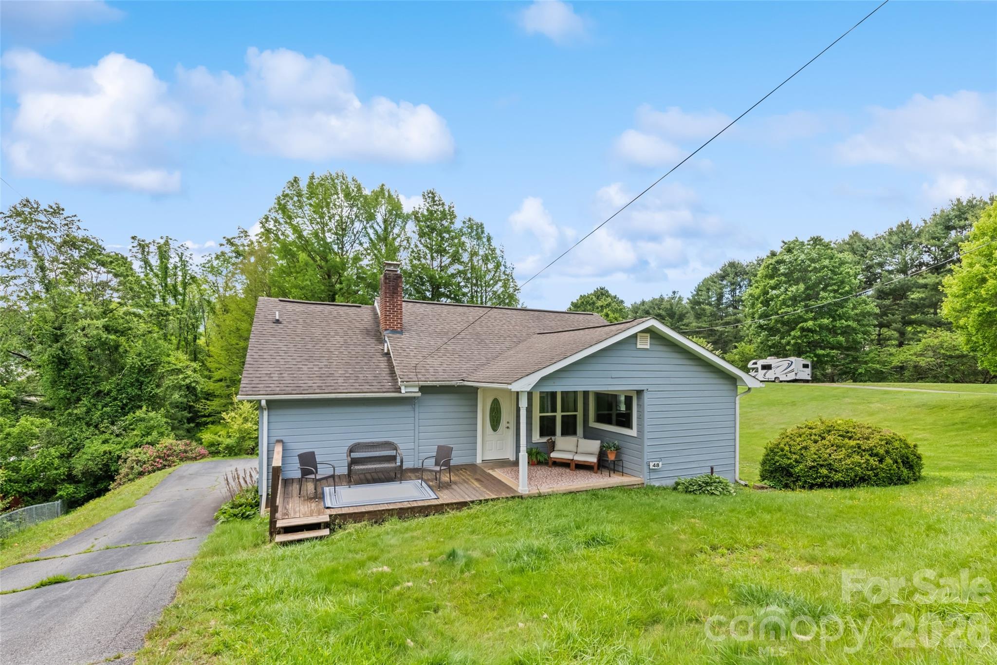 Back on the market with a $5,000 seller credit. Welcome to 48 Medford, a charming site-built single-family home just five minutes from downtown Waynesville with newly installed floors in the kitchen and dining room. This two-bedroom, two-bath home offers two en-suite baths, original hardwood floors and a beautiful stone fireplace that anchors the living area. Enjoy long-range mountain views and a peaceful country feel while being close to everyday amenities, shops, dining and local attractions. The finished attic, while unheated, provides valuable additional space for storage, hobbies or potential guest accommodations. Short-term rentals are permitted, making this a great option for an investment property, mountain retreat or full-time residence. Furnishings are optional.