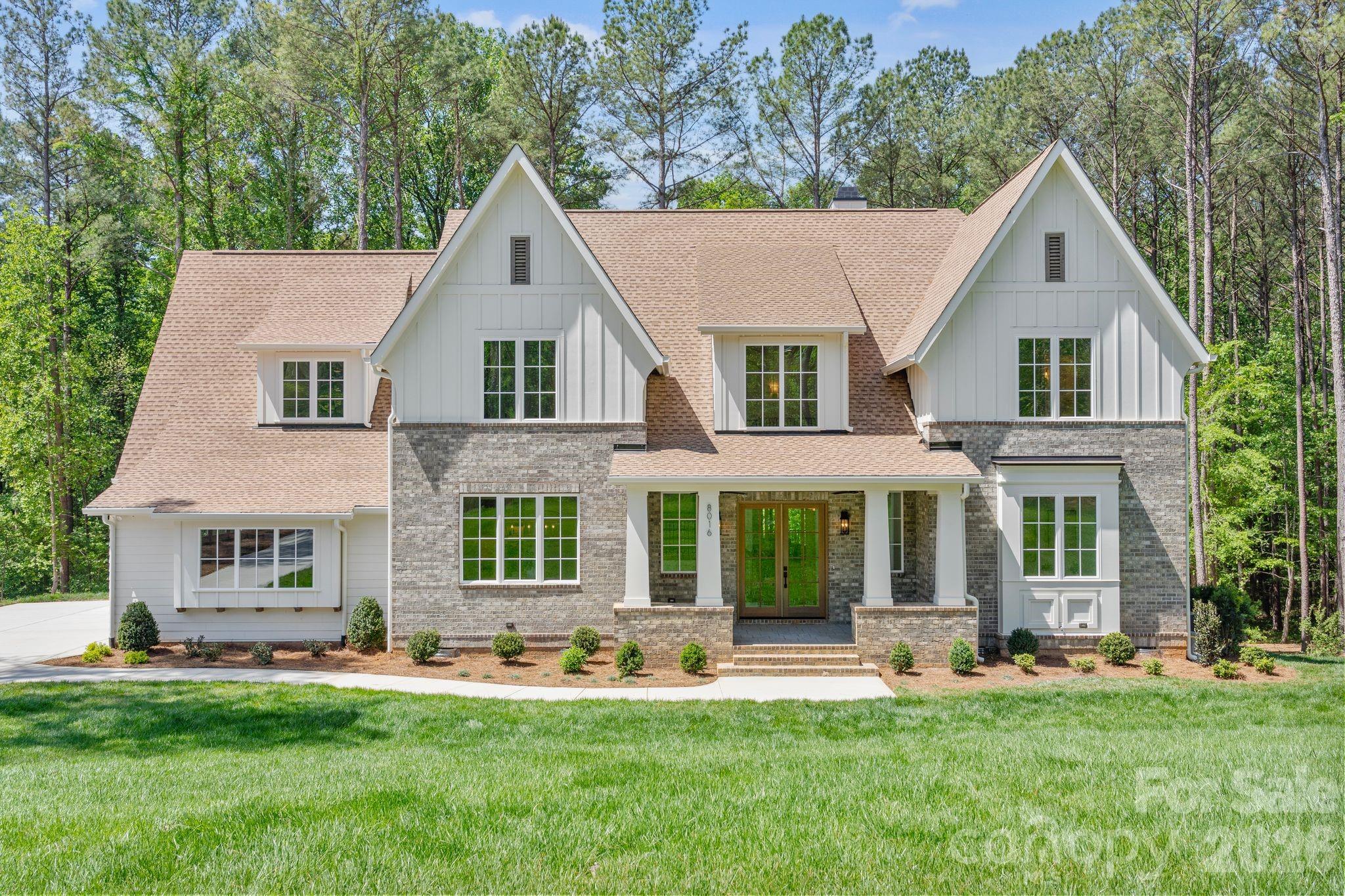 Experience a luxurious lifestyle in this exceptional estate located in Riverchase Estates, part of TK Construction’s exclusive custom luxury division—where timeless elegance meets intentional design.

This signature build showcases superior craftsmanship and meticulous attention to detail throughout. Every space has been thoughtfully designed, featuring intricate architectural elements and elevated finishes at every turn. 

An inviting front porch and entryway welcome you home, accented by custom-tailored columns. Just inside, you are greeted by a custom-crafted staircase with striking scale and elegance, complemented by an extensive trim package that enhances the architectural detail throughout the walls.

The kitchen is complemented by a full suite of stainless-steel appliances, including a striking 48” gas dual-oven range. Custom cabinetry extends seamlessly to the ceiling, enhancing both storage and architectural presence. A dramatic custom quartz backsplash accents the range and pairs beautifully with the bespoke range hood.
A farmhouse-style sink is positioned beneath oversized windows, allowing abundant natural light to pour in and showcase the kitchen’s refined finishes. This one-of-a-kind home also features a scullery and butler’s pantry thoughtfully located between the kitchen and dining room—perfect for effortless entertaining and serving as a secondary prep kitchen. Just off the kitchen, a cozy breakfast nook provides the perfect setting for intimate morning meals.

The kitchen flows effortlessly into an oversized great room with a breathtaking focal-point chandelier highlighted by a beautifully framed custom cast-stone fireplace with fire balls that blend warmth with refined style. Expansive multi-panel sliding glass doors open to a spacious screened porch, complete with a versatile two-purpose fireplace—gas or wood-burning with gas assist—ideal for cool southern evenings.

Overlooking a serene nature preserve, the screened-in porch and backyard offers peaceful wildlife views while filling the home with abundant natural light and creating a seamless connection between indoor and outdoor living. This inviting space is perfect for entertaining or simply relaxing and enjoying the surrounding landscape.

The main-level owner’s suite offers exceptional convenience and stunning views of the nature preserve. Dual owner’s closets provide ample storage, including one thoughtfully designed with a built-in bench. The primary bath features a relaxing soaking tub, a spacious walk-in shower with frameless glass enclosure, and a private water closet for added comfort.

Also on the main level is a secondary bedroom with a full bath—ideal for guests or a private home office. The laundry room is equipped with a utility sink and functional drop zone, offering direct access to the backyard, making it perfect for outdoor projects and everyday convenience.

Upstairs, the home continues to impress with a spacious bonus room with wet bar, three additional large-scale bedrooms, flexible office space, and an additional laundry room closet for added convenience.

This build is the perfect blend of luxury, comfort, and intelligent design—crafted for those who appreciate refined southern living at its finest.

Located in Riverchase Estates, a gated community features a multi–million-dollar clubhouse offering an exceptional collection of high-end amenities. Residents enjoy a fitness center, an elegant event/ballroom with direct access to an outdoor entertaining terrace complete with a fireplace and TV, and a resort-style freeform swimming pool.

Additional amenities include tennis courts, scenic ponds with fountains, picnic areas, and walking trails. The community also provides access to the Catawba River, ideal for wildlife viewing, kayaking, fishing, and a variety of outdoor recreational activities. 

Come escape everyday life at 8016 Gulf Creek and embrace the luxurious life-style in this resort-style retreat.