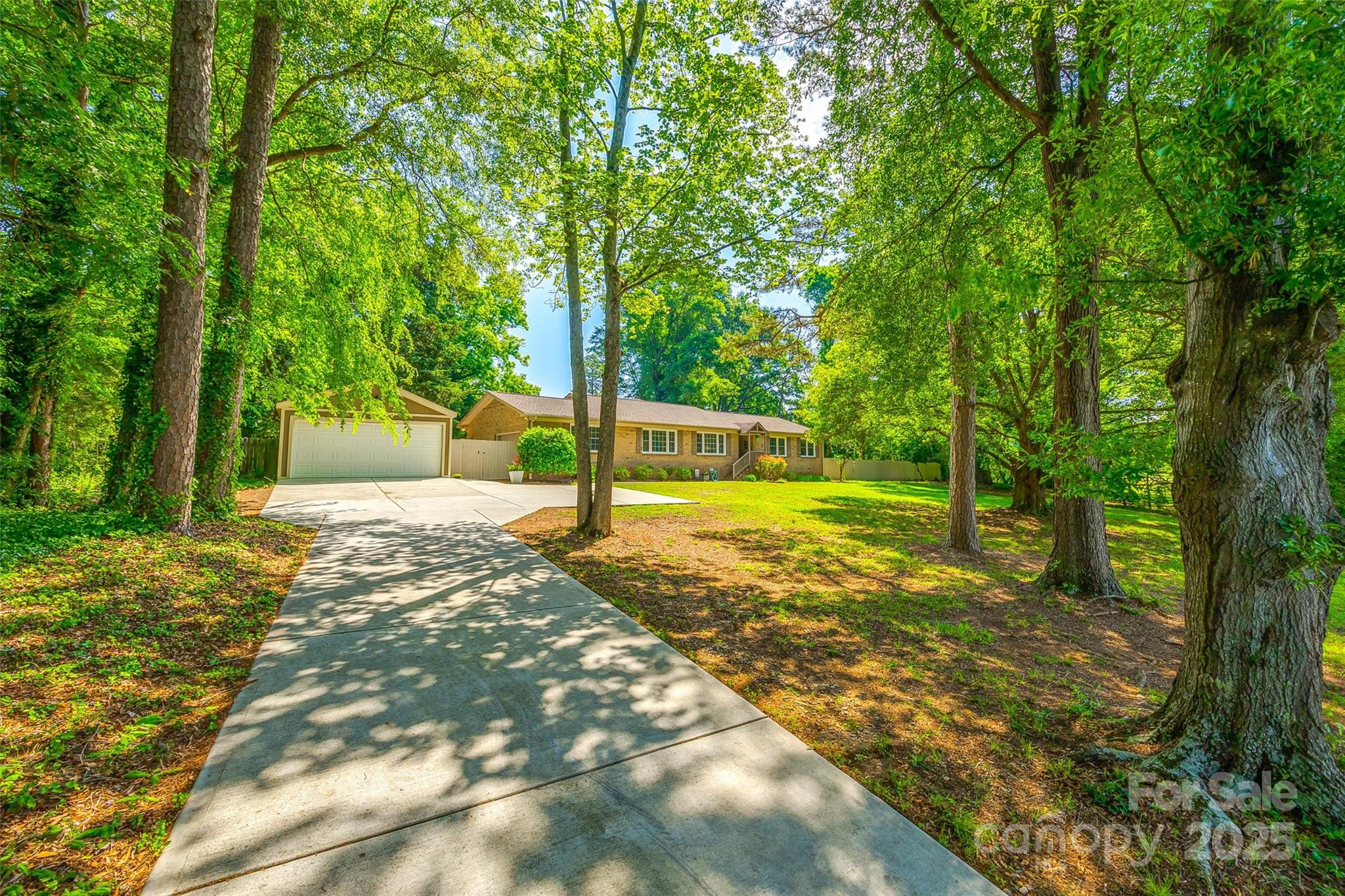 Gorgeous sprawling brick ranch with 2 car garage nestled amongst mature trees, & minutes from downtown Fort Mill.  This home offers an open layout and updated finishes.   The large great room is the heart of the home & has a separate sitting space over looking large windows.  The dining room flows right into the kitchen where you will find cream cabinets, a large island perfect for additional seating, stainless appliances, and an additional breakfast nook that overlooks the back yard.  A convenient mudroom has lots of additional storage & counter space.  The Primary bedroom offers site finished hardwoods, & an updated primary bath with tile and a walk in shower.  Head out to the back yard to enjoy the screened in porch that overlooks the large backyard with pool & expansive deck- perfect for your Summer gatherings.  The 2 car garage has a built in bench for a workshop space - ideal for all the projects.
Septic system serviced & inspected & pumped May 2025.