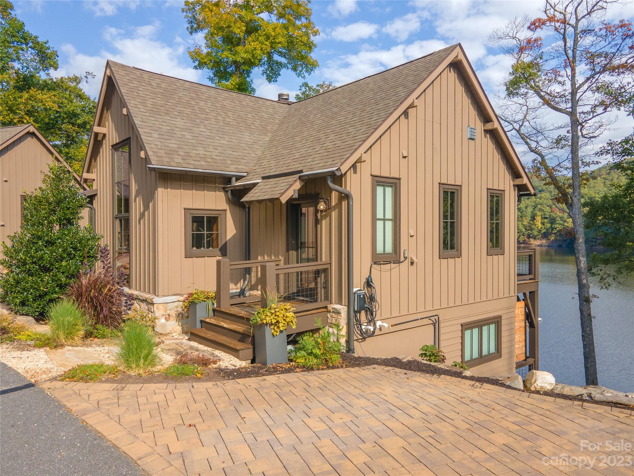 This extraordinary WATERFRONT property is nestled within Bear Lake Reserve, and it boasts a unique location close to the lake club.  The home features an open floor plan on the main level, complete with large windows that provide breathtaking views of Bear Creek Lake. On main level, you'll discover the primary bedroom with an ensuite bathroom, as well as a convenient half bath situated off the living room for visiting guests.Descending to the lower level, you'll find two more bedrooms, each with their own bathrooms, and an additional deck featuring a hot tub, perfect for enjoying the crisp evenings. Notably, this property comes with the added convenience of a whole-house generator and a home charging station compatible with most EV models. Bear Lake Reserve offers a wide array of amenities to cater to everyone's interests. Some of the amenities include on-site restaurants, pools, hot tubs, gym, boating, golf, tennis/pickleball, hiking trails, and much more!