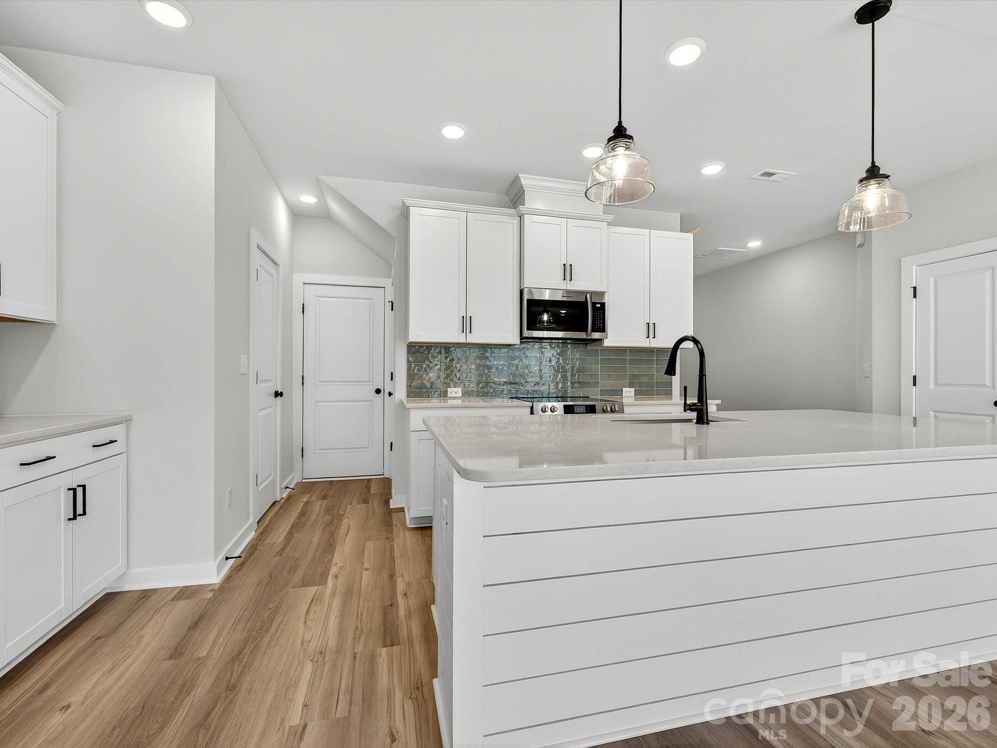 Discover the ease of luxury low-maintenance living in this brand-new Thornhurst II townhome, conveniently located just minutes from Ballantyne, Waverly, and the charming shops and restaurants of historic downtown Waxhaw.
Filled with natural light, the open-concept living area is highlighted by three large picture windows overlooking a private wooded backyard. The designer kitchen features 42” Frost-colored soft-close cabinetry, sleek quartz countertops, a spacious island open to the family room, Frigidaire stainless steel appliances, an exterior-vented range hood, and a pantry with solid shelving.
The main level showcases durable LVP flooring throughout, along with composite stair treads leading to the second floor. Upstairs, unwind in the luxurious Owner’s Retreat featuring a tray ceiling, oversized walk-in closet, and three large windows that create a bright, airy feel. The spa-inspired primary bath offers tiled flooring, a large tiled walk-in shower with bench seating, dual vanities with quartz countertops and soft-close cabinetry, a linen closet, and a private water closet.
The second floor also includes two spacious secondary bedrooms, a full hall bath, and a thoughtfully designed laundry room with tiled flooring and a convenient folding table.
Enjoy peaceful mornings or relaxing evenings on the covered porch overlooking the wooded backyard. A side-by-side two-car garage and full driveway provide ample parking for both homeowners and guests.
With low taxes, low-maintenance living, and the feel of a single-family home, this townhome offers the perfect blend of comfort, convenience, and style. Ask about special low-interest rate opportunities!