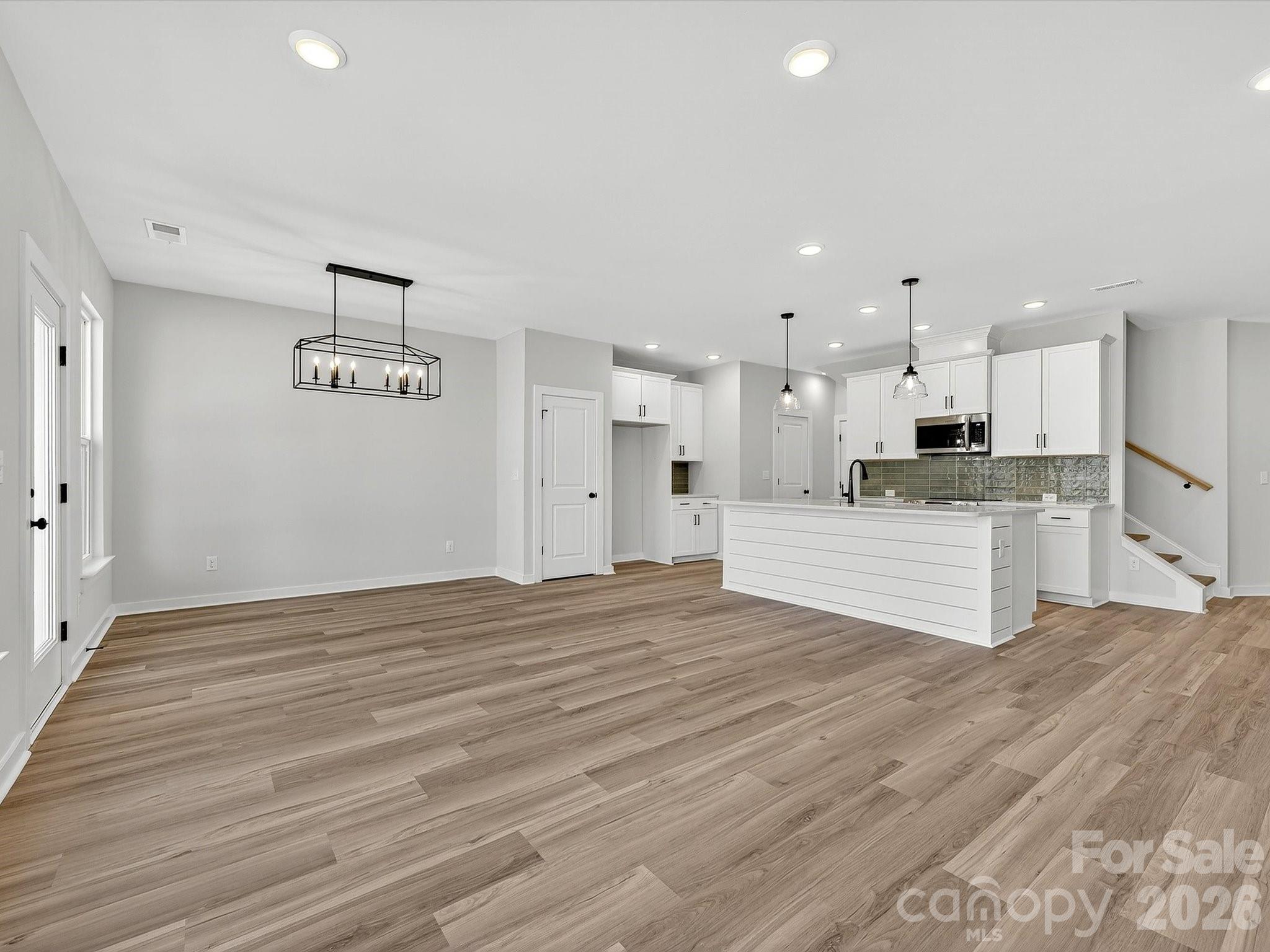 Discover the ease of luxury low-maintenance living in this brand-new Thornhurst II townhome, conveniently located just minutes from Ballantyne, Waverly, and the charming shops and restaurants of historic downtown Waxhaw.
Filled with natural light, the open-concept living area is highlighted by three large picture windows overlooking a private wooded backyard. The designer kitchen features 42” Frost-colored soft-close cabinetry, sleek quartz countertops, a spacious island open to the family room, Frigidaire stainless steel appliances, an exterior-vented range hood, and a pantry with solid shelving.
The main level showcases durable LVP flooring throughout, along with composite stair treads leading to the second floor. Upstairs, unwind in the luxurious Owner’s Retreat featuring a tray ceiling, oversized walk-in closet, and three large windows that create a bright, airy feel. The spa-inspired primary bath offers tiled flooring, a large tiled walk-in shower with bench seating, dual vanities with quartz countertops and soft-close cabinetry, a linen closet, and a private water closet.
The second floor also includes two spacious secondary bedrooms, a full hall bath, and a thoughtfully designed laundry room with tiled flooring and a convenient folding table.
Enjoy peaceful mornings or relaxing evenings on the covered porch overlooking the wooded backyard. A side-by-side two-car garage and full driveway provide ample parking for both homeowners and guests.
With low taxes, low-maintenance living, and the feel of a single-family home, this townhome offers the perfect blend of comfort, convenience, and style. Ask about special low-interest rate opportunities!