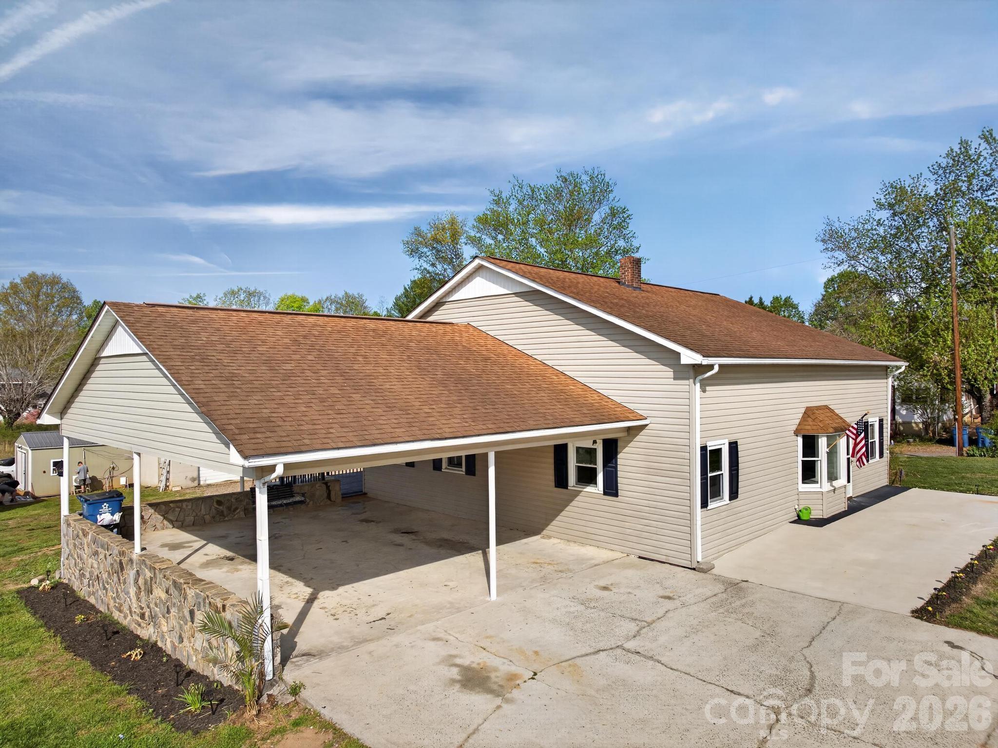 Remarkable property in the desirable Hudson/Sawmills area—perfect for the craftsman, hobbyist, or car enthusiast! The standout feature is the impressive two-bay garage, fully equipped with power and compressor hookup, offering endless possibilities for projects or storage. Adjacent to the garage, a finished outbuilding provides additional flexibility with a mini-split HVAC system, water heater, and sink—ideal for a workshop, studio, or bonus space.

The property offers abundant parking with a spacious driveway and two-car carport. Inside, you’ll appreciate the rustic charm, highlighted by a faux wood beam ceiling and cozy wood-burning stove. The kitchen features stylish black cabinetry, upgraded gold hardware, and warm butcher block countertops.

A main-level laundry closet is conveniently located in the third bedroom. Plus, don’t miss the nearly finished attic space—over 500 square feet with tall ceilings and permanent stairs—ready to be customized to fit your needs.

Virtual staging added to photos.
