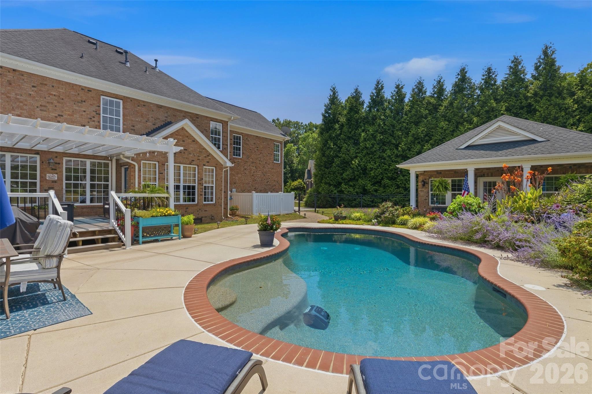 A Rare Opportunity...The Unicorn You've Been Waiting For!

Welcome to your own private resort and paradise where every season brings a new display of breathtaking gardens, lush landscaping, and peaceful outdoor living. Tucked away on a quiet cul-de-sac on nearly an acre in the highly sought-after Weddington school district, this truly one-of-a-kind property offers the perfect blend of quality, flexibility, and everyday comfort—all with low Union County taxes.

Full brick, custom built by the original owners and designed for those who love to entertain and unwind, the incredible backyard retreat features expansive Trex decking that is pergola-covered outdoor living area, and a sparkling in-ground pebble-tech pool with salt chlorinator, surrounded by mature landscaping that creates exceptional privacy. The crown jewel is the rare full brick detached guest/pool house (ADU)—an extraordinary bonus complete with a kitchenette, full bath, Murphy bed custom designed by California Closets, and endless possibilities. Use it as a guest suite, home office, recreation room, fitness studio, art space, or private work-from-home retreat.

Lovingly and beautifully maintained, the home showcases hardwood flooring throughout the main level and fresh interior paint. The welcoming floor plan offers formal living or study, elegant dining room, and a stunning great room highlighted by a cozy gas fireplace and a dramatic wall of windows framing spectacular pool and garden views. The light-filled breakfast room flows seamlessly into the kitchen featuring granite countertops, stainless steel appliances, gas range, breakfast bar seating, abundant cabinetry, and the convenience of two pantries.

Upstairs, escape to the spacious owner's suite featuring an ensuite bath with dual sink vanity, soaking garden tub, separate shower, and oversized walk-in closet. Three additional bedrooms, a full bath, and an upstairs laundry room provide exceptional functionality. A generous bonus room offers tremendous flexibility as a potential fifth bedroom, media room, game room, or music studio.

Additional highlights include an oversized side-load two-car garage, impeccable landscaping, and outdoor spaces that truly feel like a year-round vacation destination.

Ideally located just minutes from Wesley Chapel Village with shopping, dining, and everyday conveniences, plus nearby parks including WCWAA Optimist Park and Dogwood Park offering sports fields, playgrounds, walking trails, and recreation for all ages. Homes offering this combination of location, privacy, outdoor living, and a detached ADU are exceptionally rare. Don't miss this extraordinary opportunity!