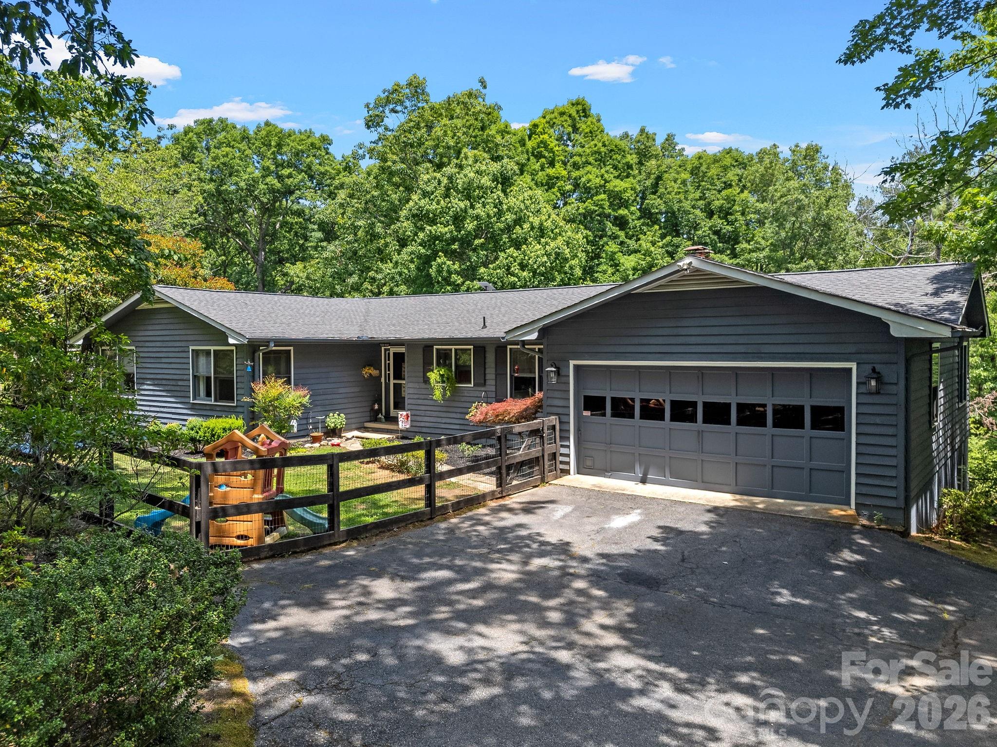 A delightful property in the desirable Gillette Woods community of Tryon.  You will be welcomed into this well cared for and inviting family home that offers plenty of living space including the living room, family room with a wood burning masonry fireplace and and enclosed sun porch and back deck. The kitchen includes all appliances. All of the bedrooms are located on the main level, and there is direct access to the basement that offers additional living area that could potentially give and option for an apartment, plus plenty of room for storage and shop area.  Fenced front and back yard for your family and pets.  This home also offers high speed internet access and is on the Tryon water system.  The HOA is optional and the Sellers are not currently members. This home has a great feeling about it and is located only minutes from downtown Tryon.  Come and take a look, this may seriously be your next special place to call home!!!